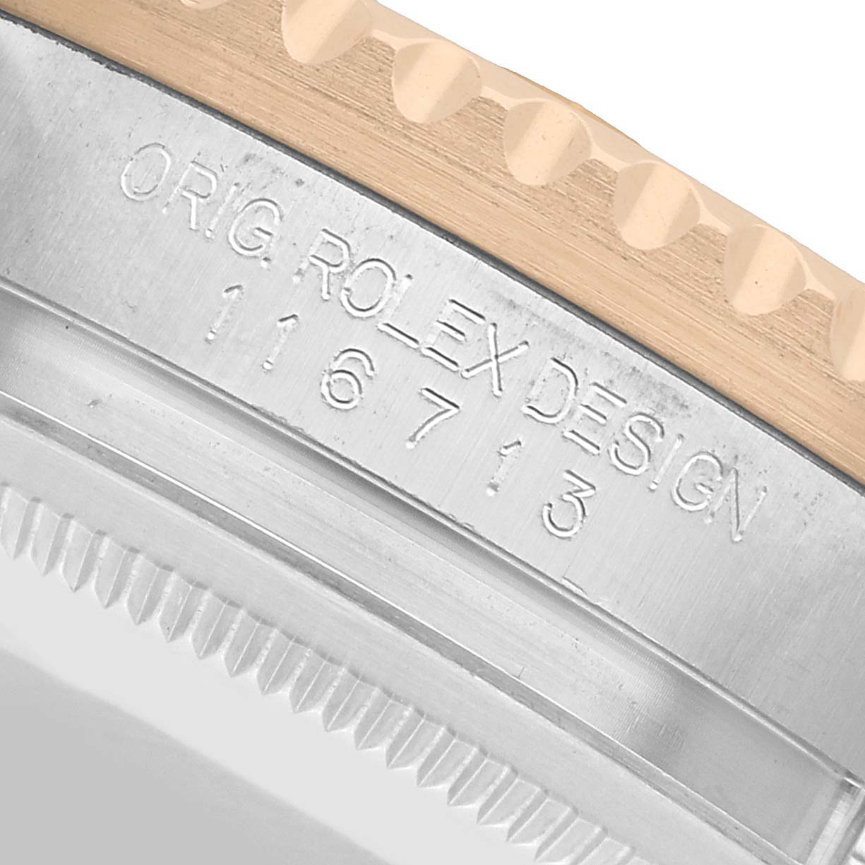 The image shows a close-up of the side engraving on the bezel and case of a Rolex GMT-Master 116713 Men's Steel and Gold (two tone) Black Dial watch.
