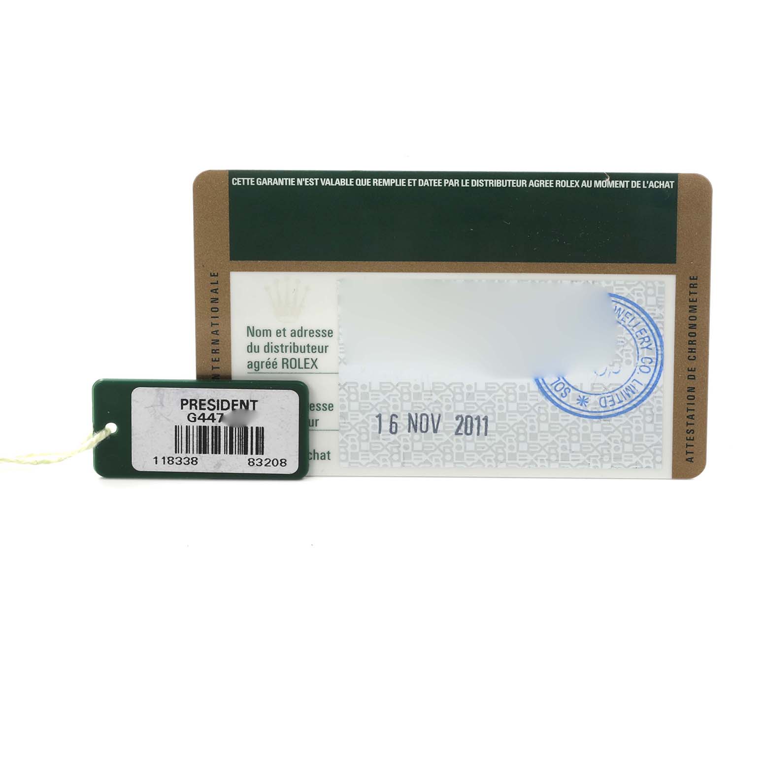 The image shows a Rolex President 118338 Men's Yellow Gold Champagne Dial 118338 Men's Yellow Gold Champagne Dial model warranty card and a green tag with barcodes.