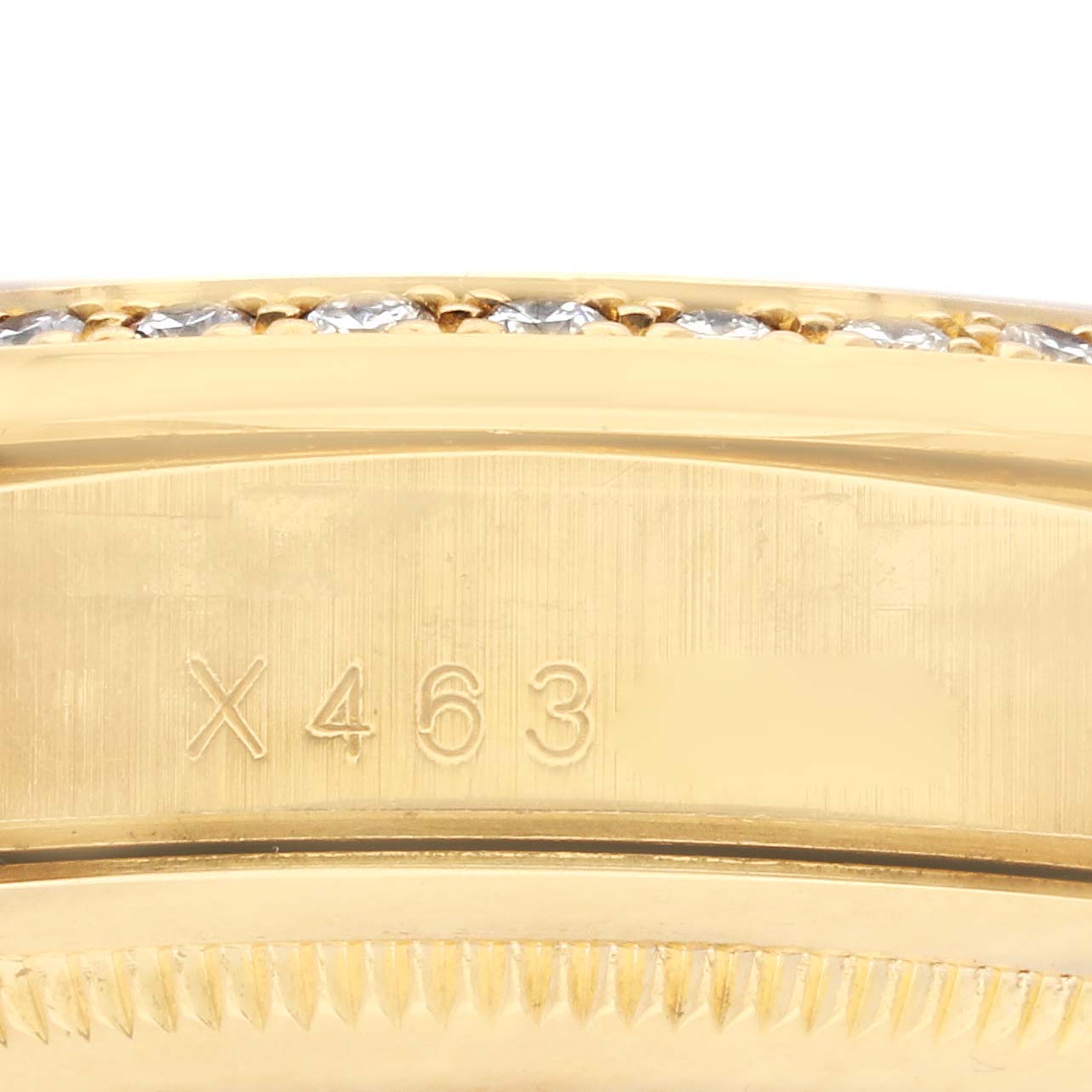 The image shows a close-up of the side of the Rolex President 18388 Men's Yellow Gold Champagne Dial 18388 Men's Yellow Gold Champagne Dial watch, featuring the gold bezel with engraved numbers.