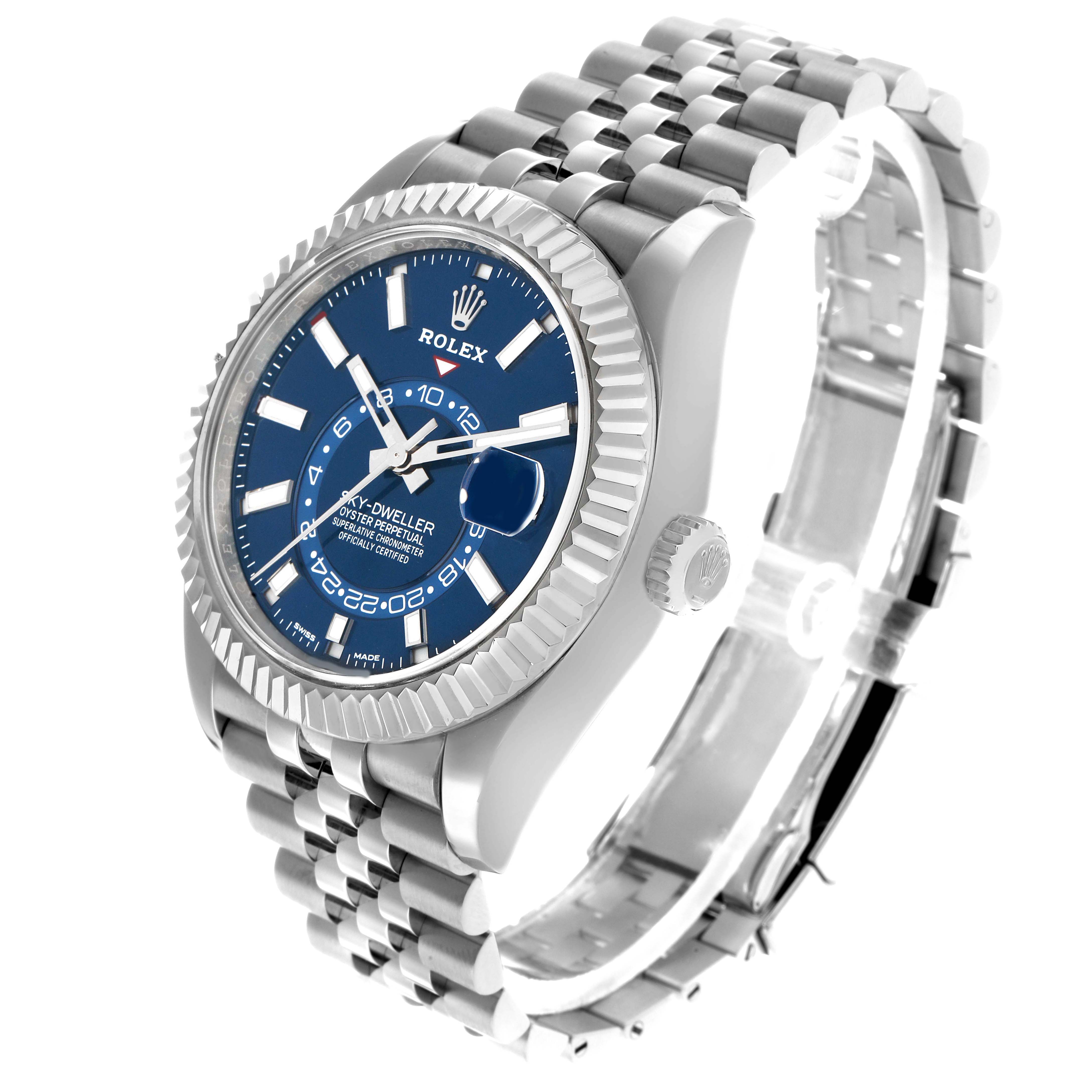 The image shows a Rolex Sky-Dweller 326934 Men's Stainless Steel Blue Dial watch at an angled side view, highlighting the blue dial, bezel, crown, and Jubilee bracelet.