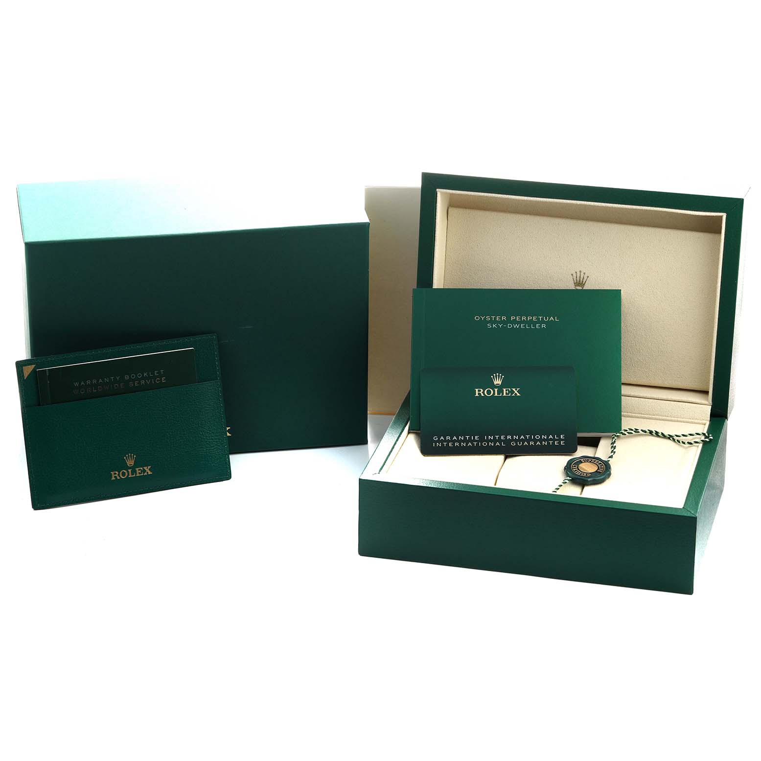 The image shows packaging and accessories for the Rolex Sky-Dweller 326934 Men's Stainless Steel Blue Dial, including boxes, booklets, and a tag.