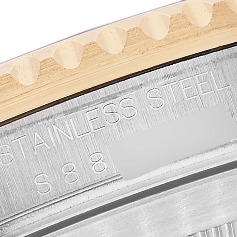 The image shows a close-up angle of the Rolex Submariner 16613 Men's Steel and Gold (two tone) Blue Dial 16613 Men's Steel and Gold (two tone) Blue Dial's bezel and part of the case, displaying the "STAINLESS STEEL" engraving.