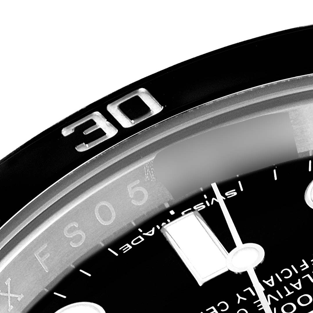 This close-up angle of the Rolex Submariner 116610 Men's Stainless Steel Black Dial 116610 Men's Stainless Steel Black Dial shows the watch's bezel and part of the dial with markers.
