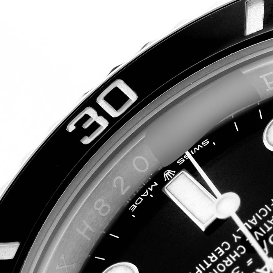 The image shows a close-up of the bezel and part of the dial of a Rolex Submariner 124060 Men's Stainless Steel Black Dial.