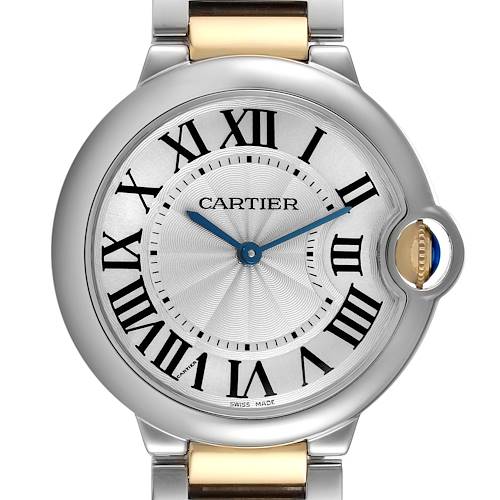 The image shows a frontal view of the Cartier Ballon Bleu watch, highlighting its circular dial, Roman numerals, and sapphire cabochon crown.