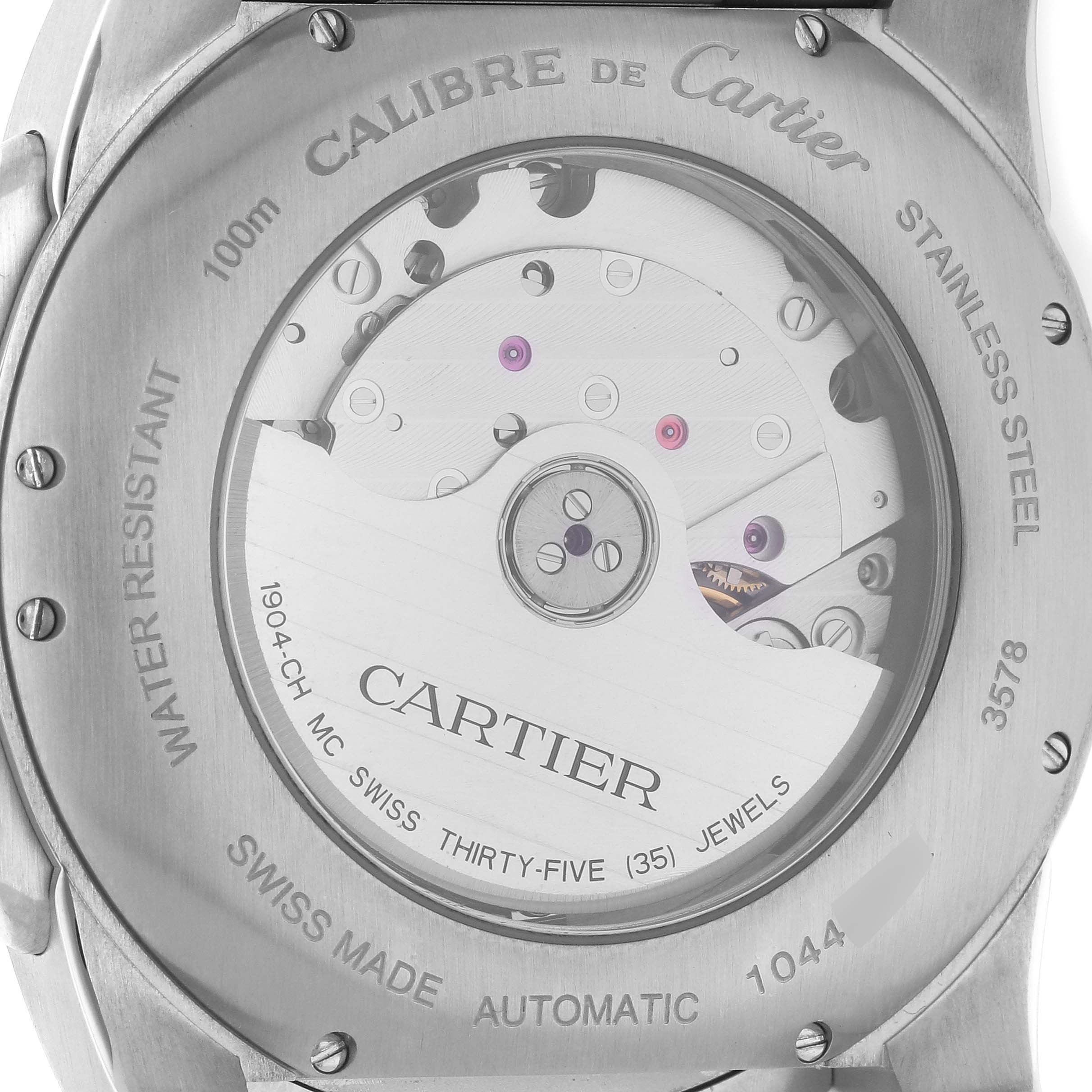 The image shows the back of a Calibre de Cartier watch, highlighting its movement and engravings.