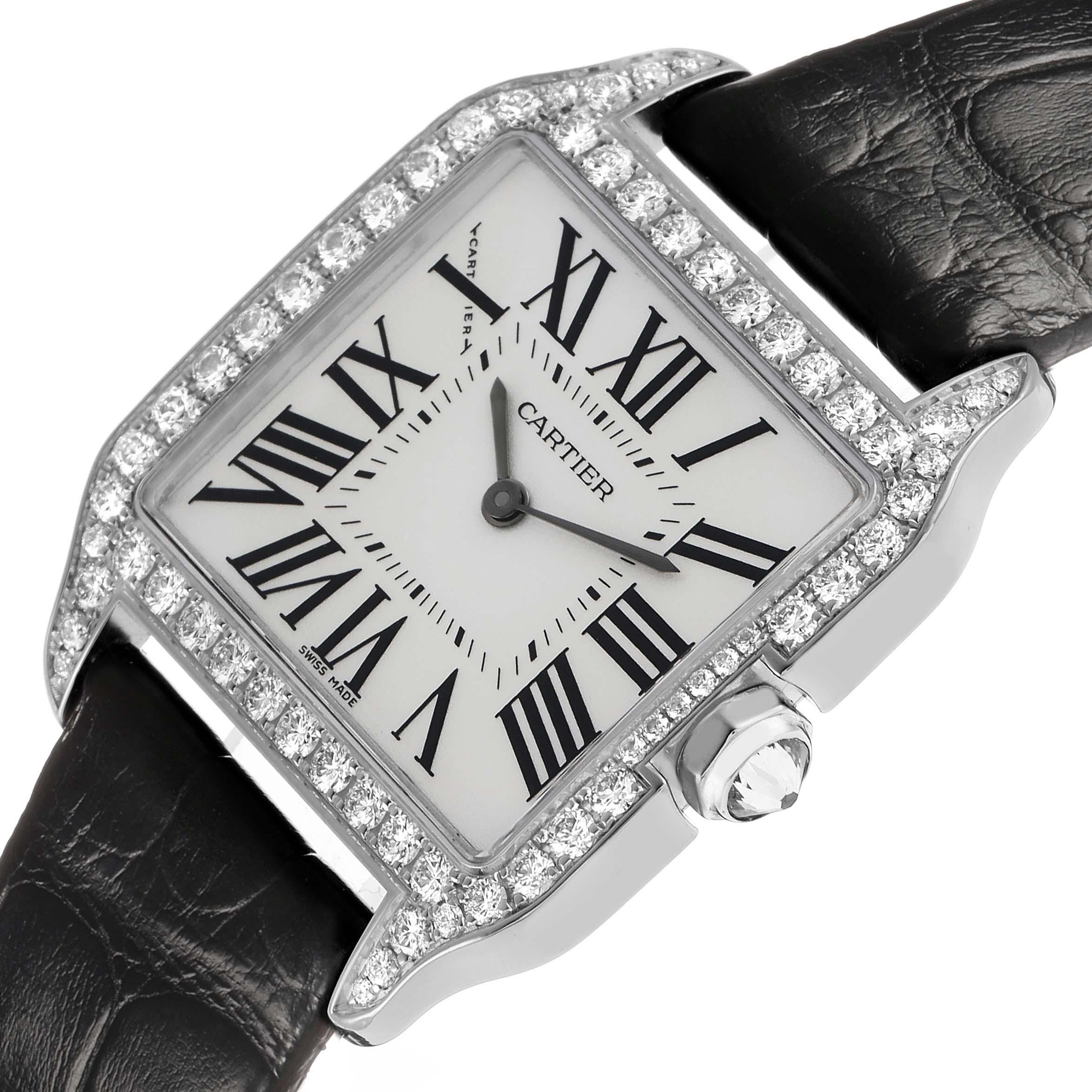 The Cartier Santos Dumont WH100251 Men's White Gold Silver Dial watch is shown from an angled view, highlighting its diamond-encrusted bezel and leather strap.