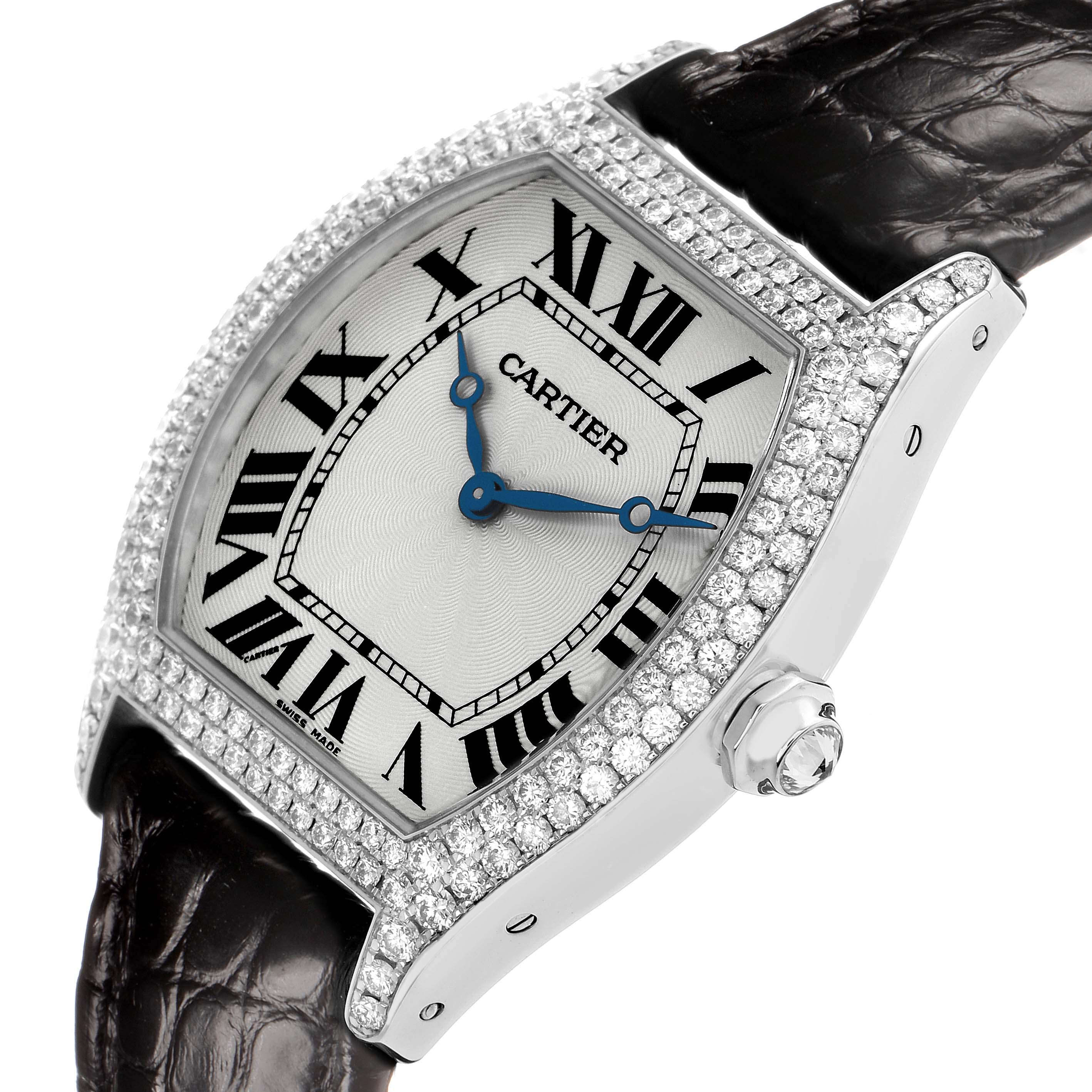 The Cartier Tortue WA504351 Men's White Gold Silver Dial watch is shown at a front angle, highlighting its diamond-encrusted case, Roman numeral dial, blue hands, and leather strap.