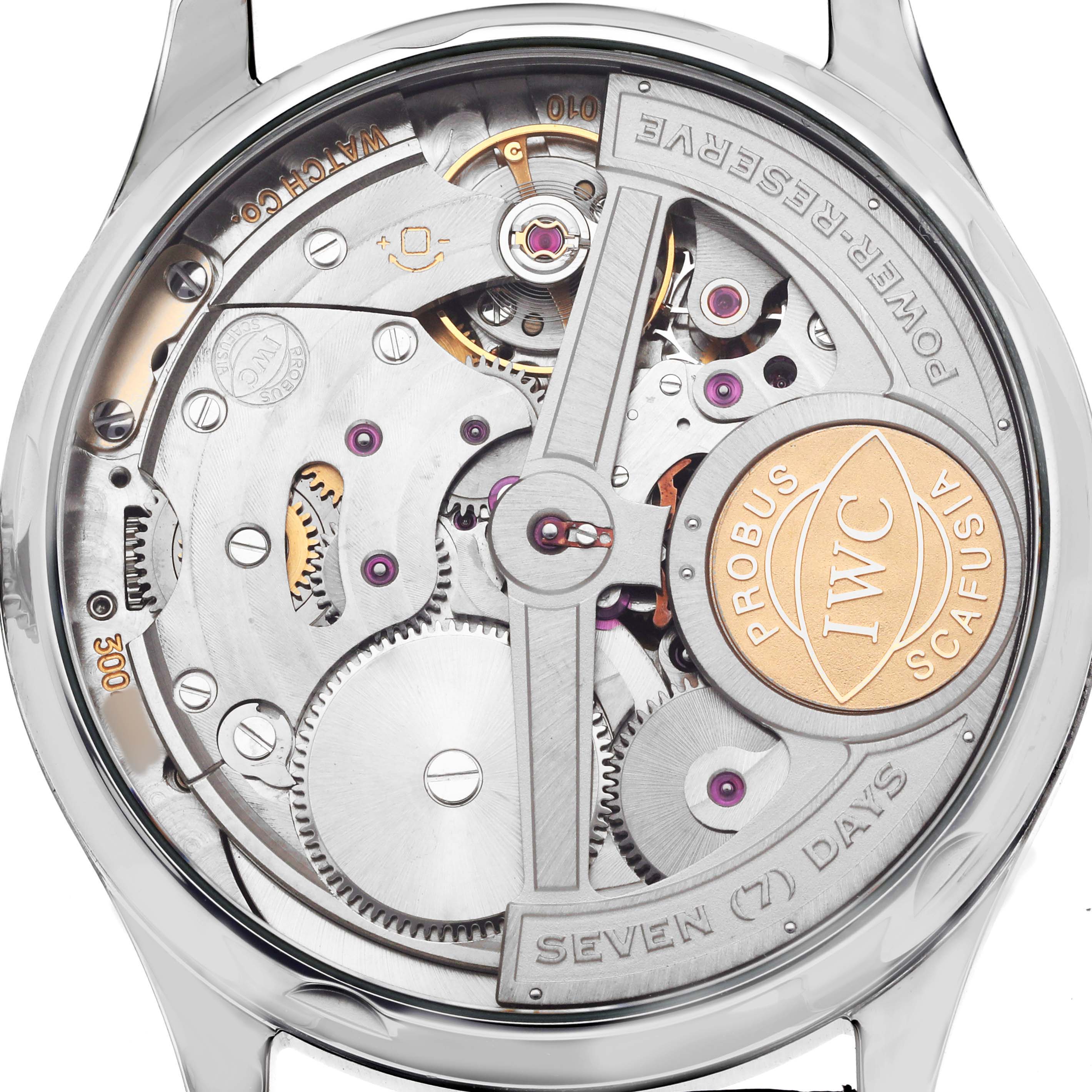 The IWC Portuguese IW500703 Men's Stainless Steel Black Dial watch is shown from the back, revealing its intricate mechanical movement and components.