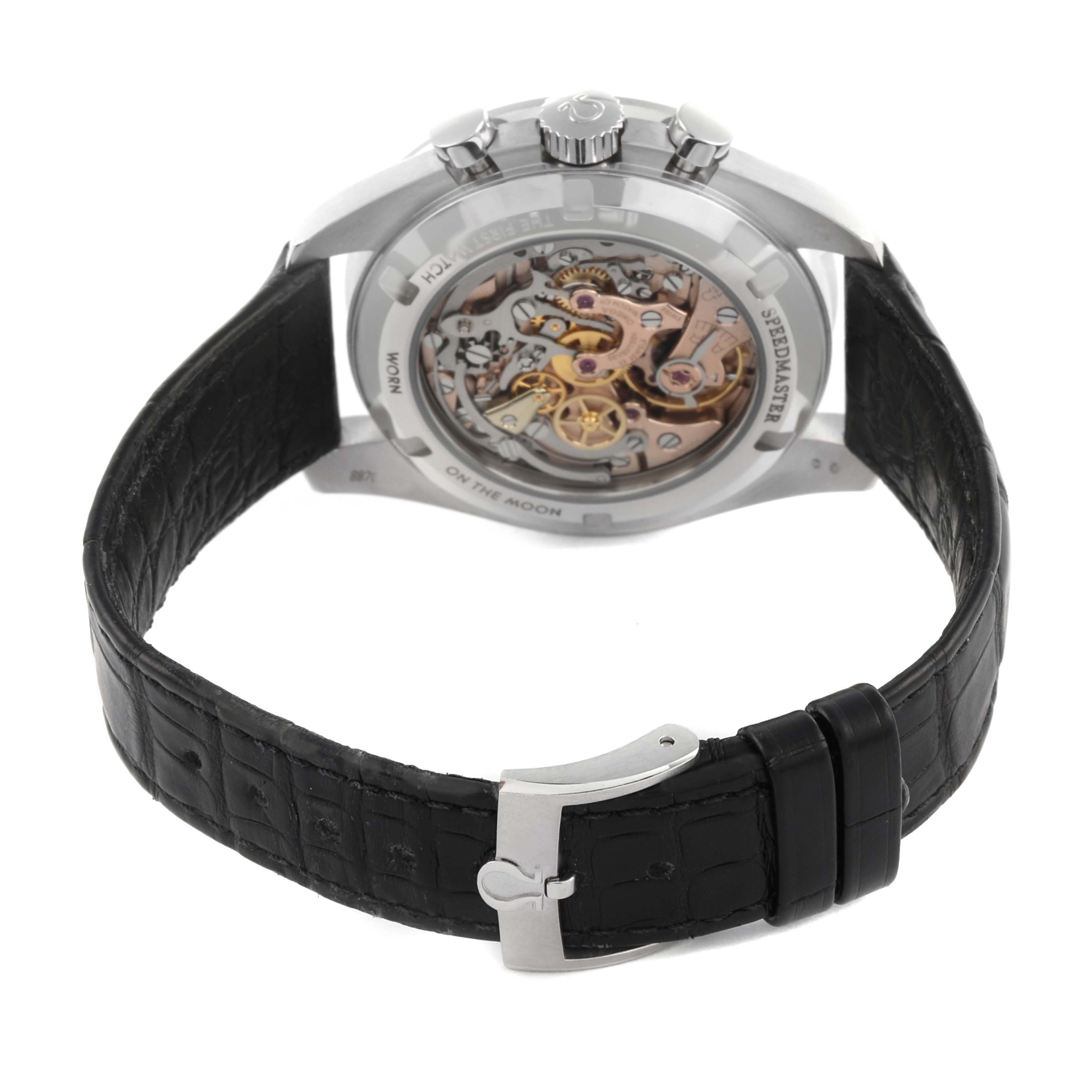 The image shows the back view of an Omega Speedmaster 311.93.42.30.99.001 Men's Platinum Black Dial 311.93.42.30.99.001 Men's Platinum Black Dial, highlighting its open caseback and movement, with a black leather strap.