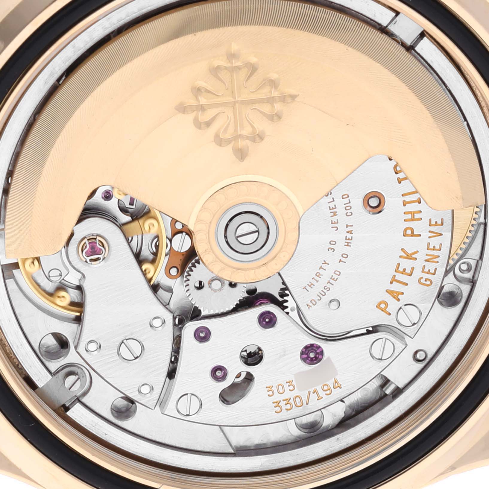 The image shows the movement of a Patek Philippe Aquanaut 5060 Men's Yellow Gold Silver Dial 5060 Men's Yellow Gold Silver Dial watch, featuring the intricate mechanical components and rotor.