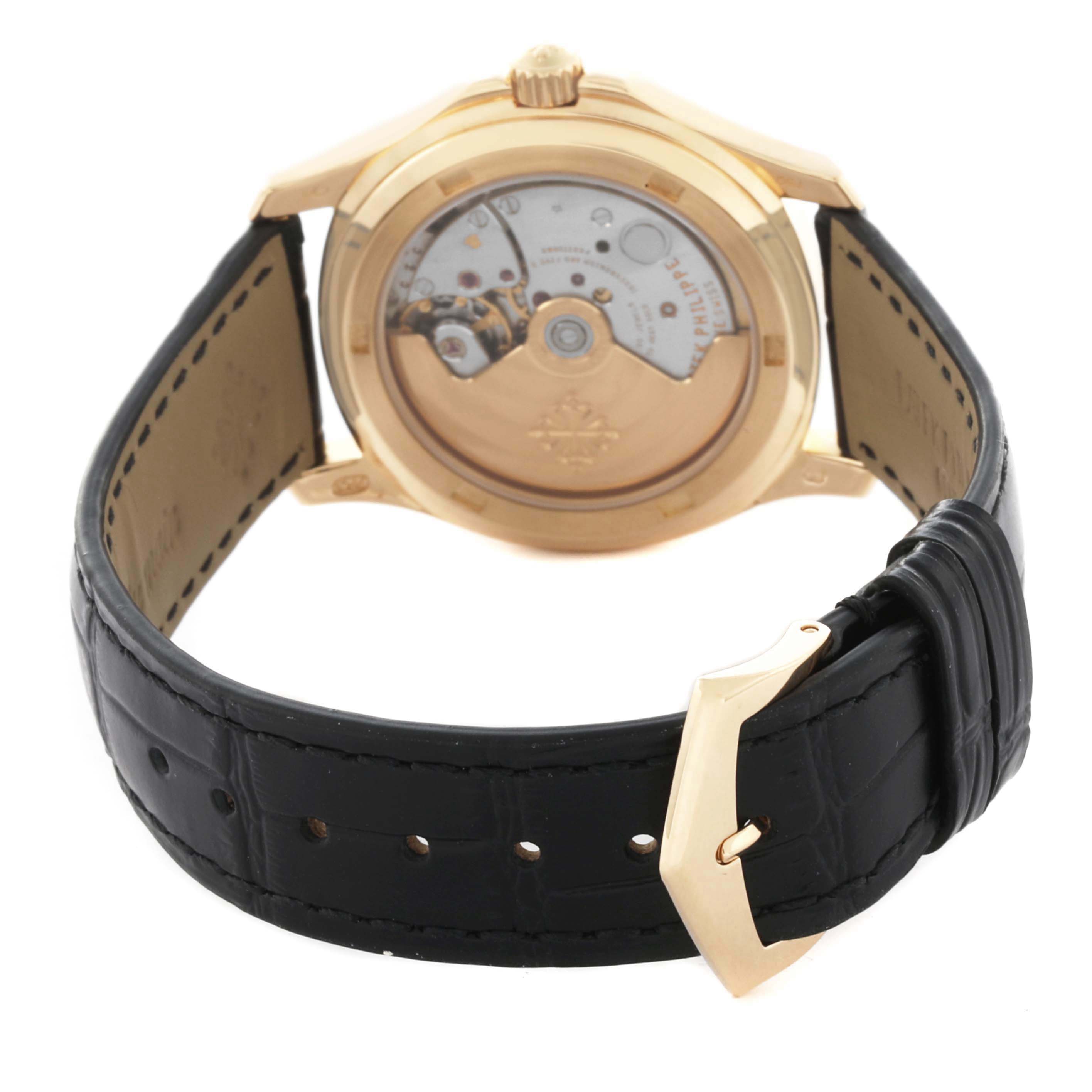 The Patek Philippe Aquanaut 5060 Men's Yellow Gold Silver Dial 5060 Men's Yellow Gold Silver Dial watch is shown from the back, displaying its open case back and leather strap.