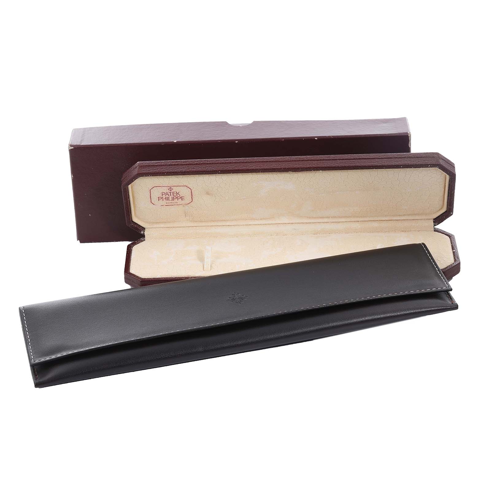 The image shows a Patek Philippe Aquanaut 5060 Men's Yellow Gold Silver Dial 5060 Men's Yellow Gold Silver Dial watch box and case at a frontal angle.