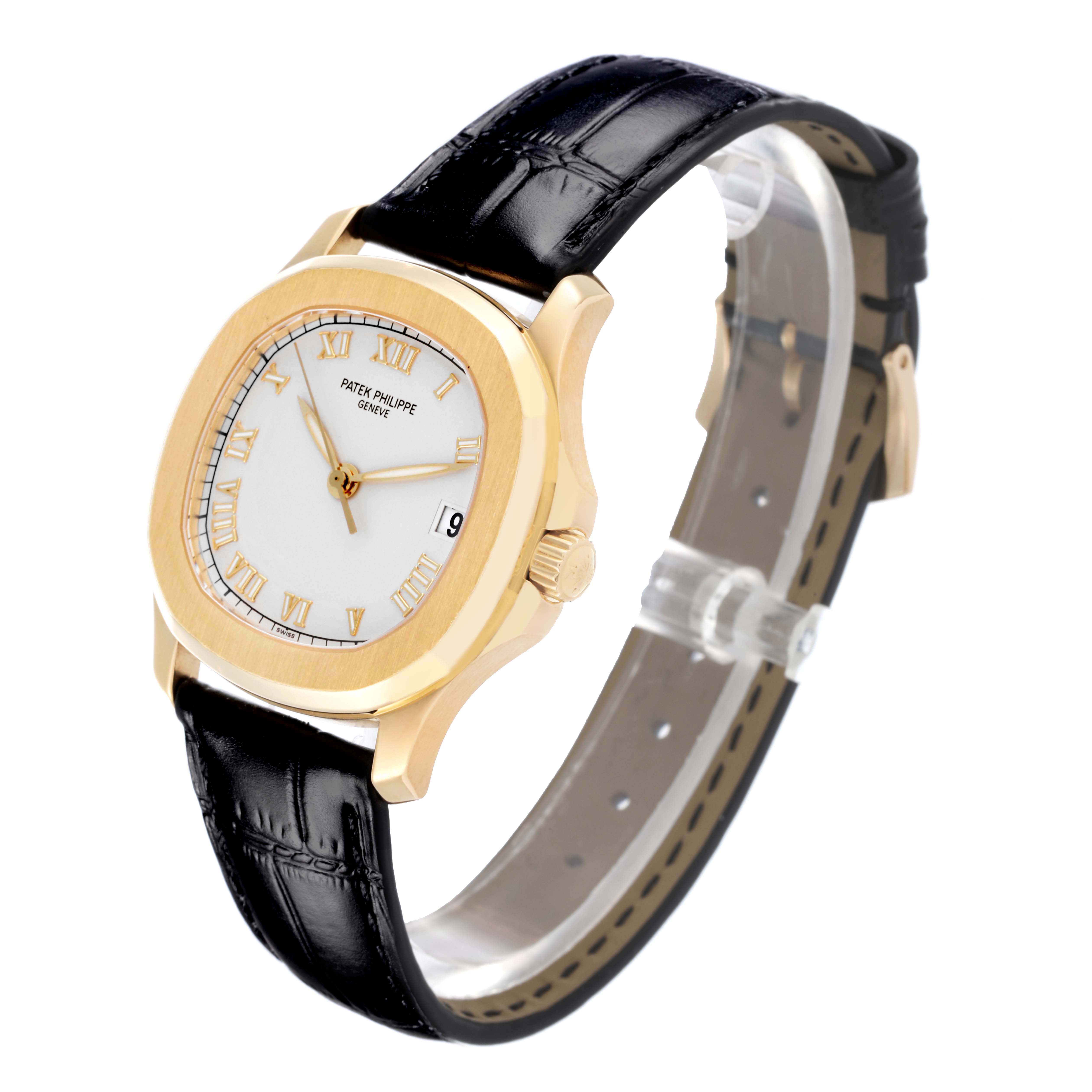 The Patek Philippe Aquanaut 5060 Men's Yellow Gold Silver Dial 5060 Men's Yellow Gold Silver Dial is shown at a slight side angle, displaying the face, black leather strap, and gold case.