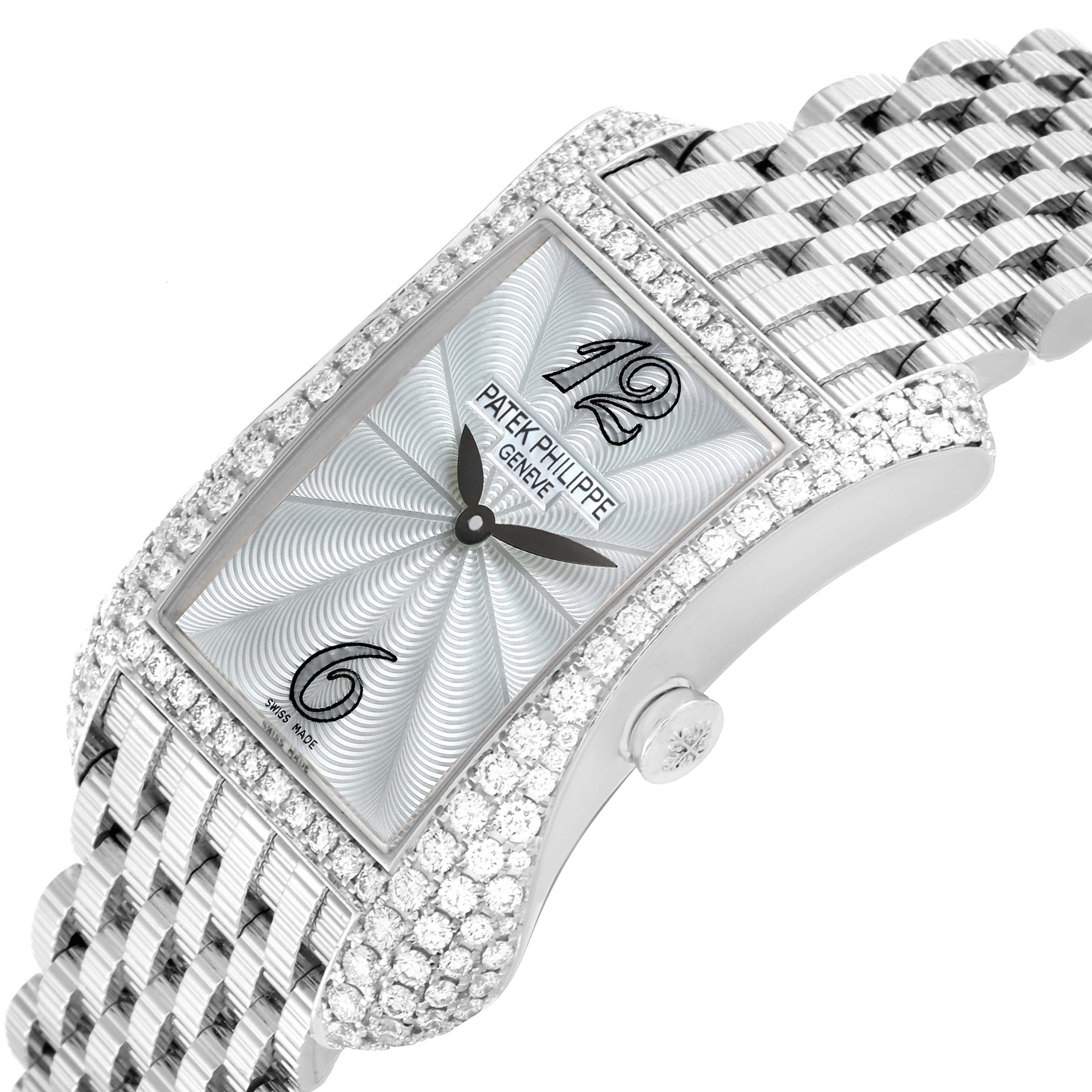 The Patek Philippe Gondolo 4972/1G-001 Women
s White Gold Mother of Pearl Dial watch is shown at an angled side view, highlighting its diamond-encrusted case and silver bracelet.