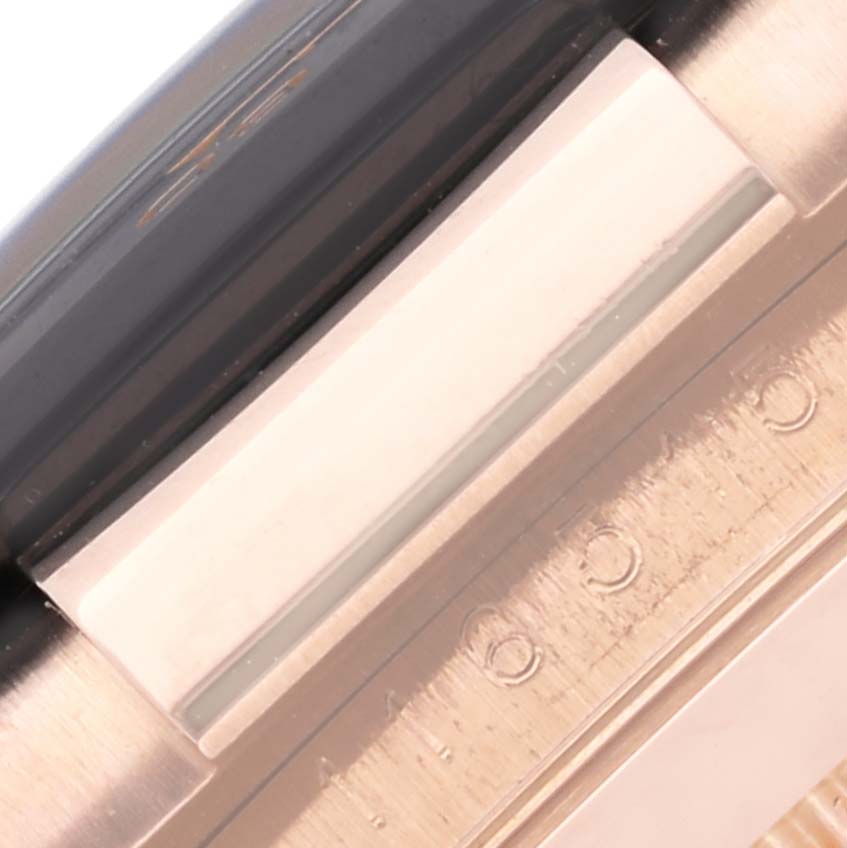 The image shows a close-up of the side of a Rolex Daytona 116515LN Men's Rose Gold Brown Dial 116515LN Men's Rose Gold Brown Dial watch, highlighting the bezel and the edge of the watch band.