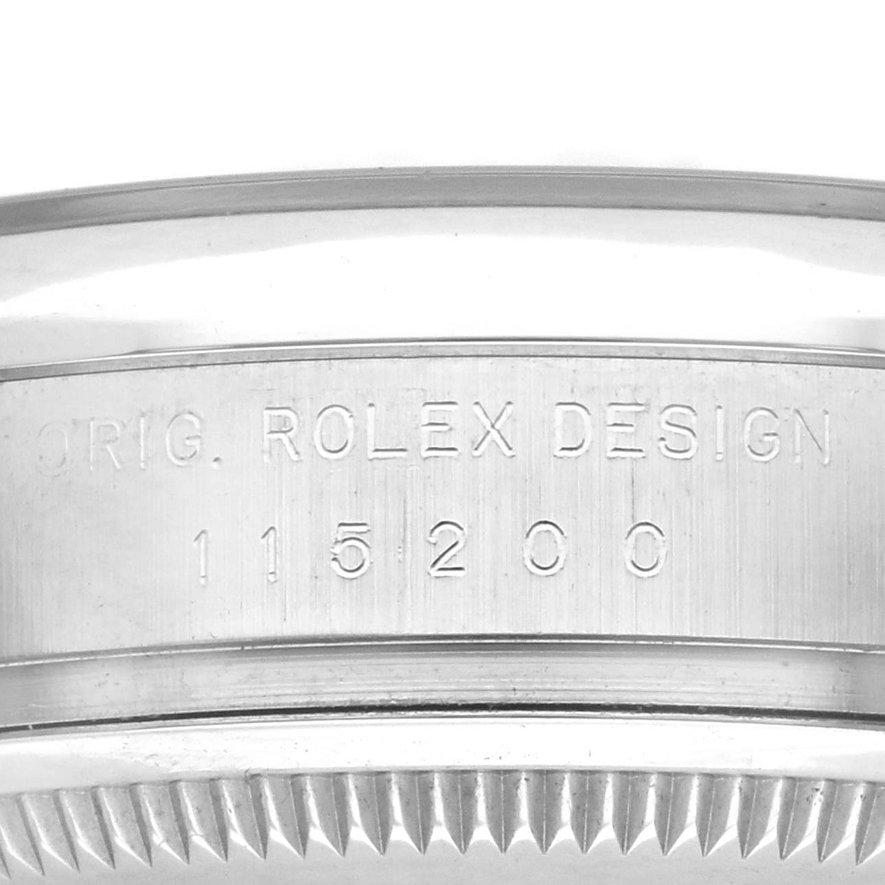 This image shows the engraved side of a Rolex Date 115200 Men's Stainless Steel Black Dial 115200 Men's Stainless Steel Black Dial model with its reference number and design details visible.