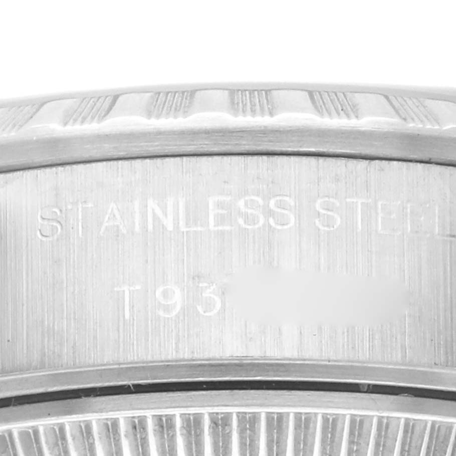 The image shows a close-up of the Rolex Date 69240 Women's Stainless Steel Blue Dial 69240 Women's Stainless Steel Blue Dial model's stainless steel case with engraved markings.