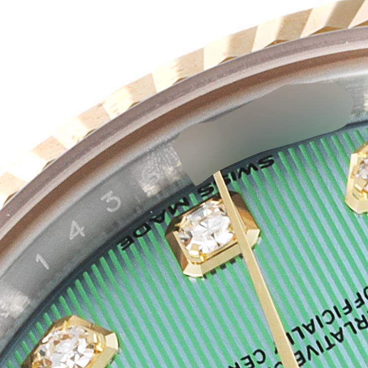 Close-up of the Rolex Datejust 279173 Women
s Steel and Gold (two tone) Green Dial 279173 Women
s Steel and Gold (two tone) Green Dial watch showing part of the dial, diamonds, and the fluted bezel.