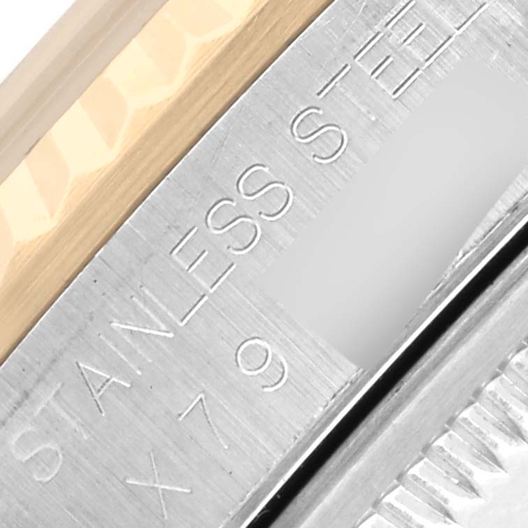 The image shows a close-up of the Rolex Datejust 16233 Men's Steel and Gold (two tone) Silver Dial 16233 Men's Steel and Gold (two tone) Silver Dial watch's bezel, highlighting the stainless steel and gold material.