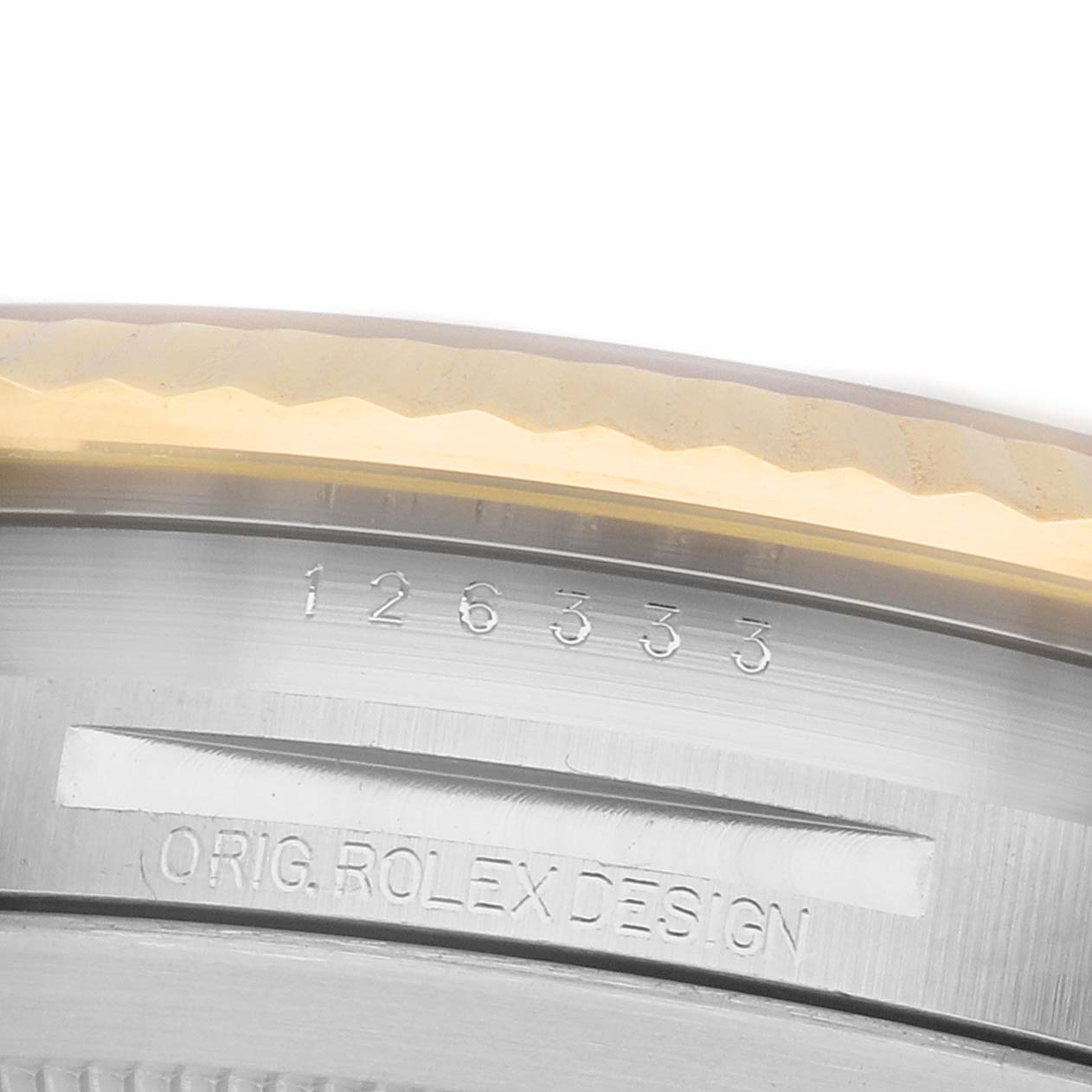 The image shows a close-up of the side of a Rolex Datejust 41 126333 Men's Steel and Gold (two tone) Champagne Dial, focusing on the bezel and engraved markings.