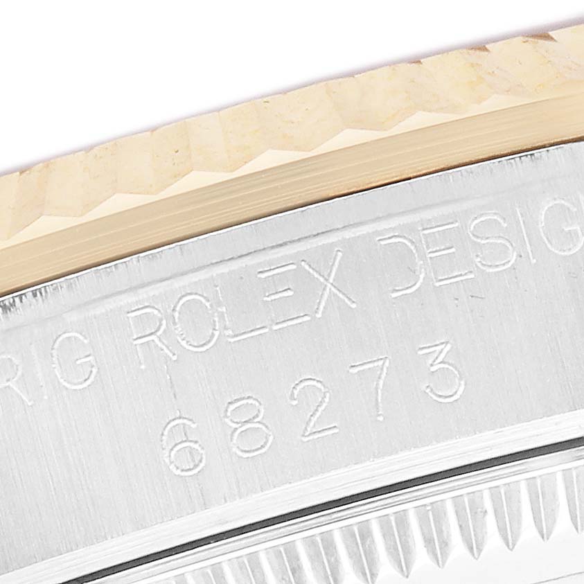 The image shows an angled view of the engraved side of a Rolex Datejust 68273 Women's Stainless Steel Silver Dial watch bezel and edge.