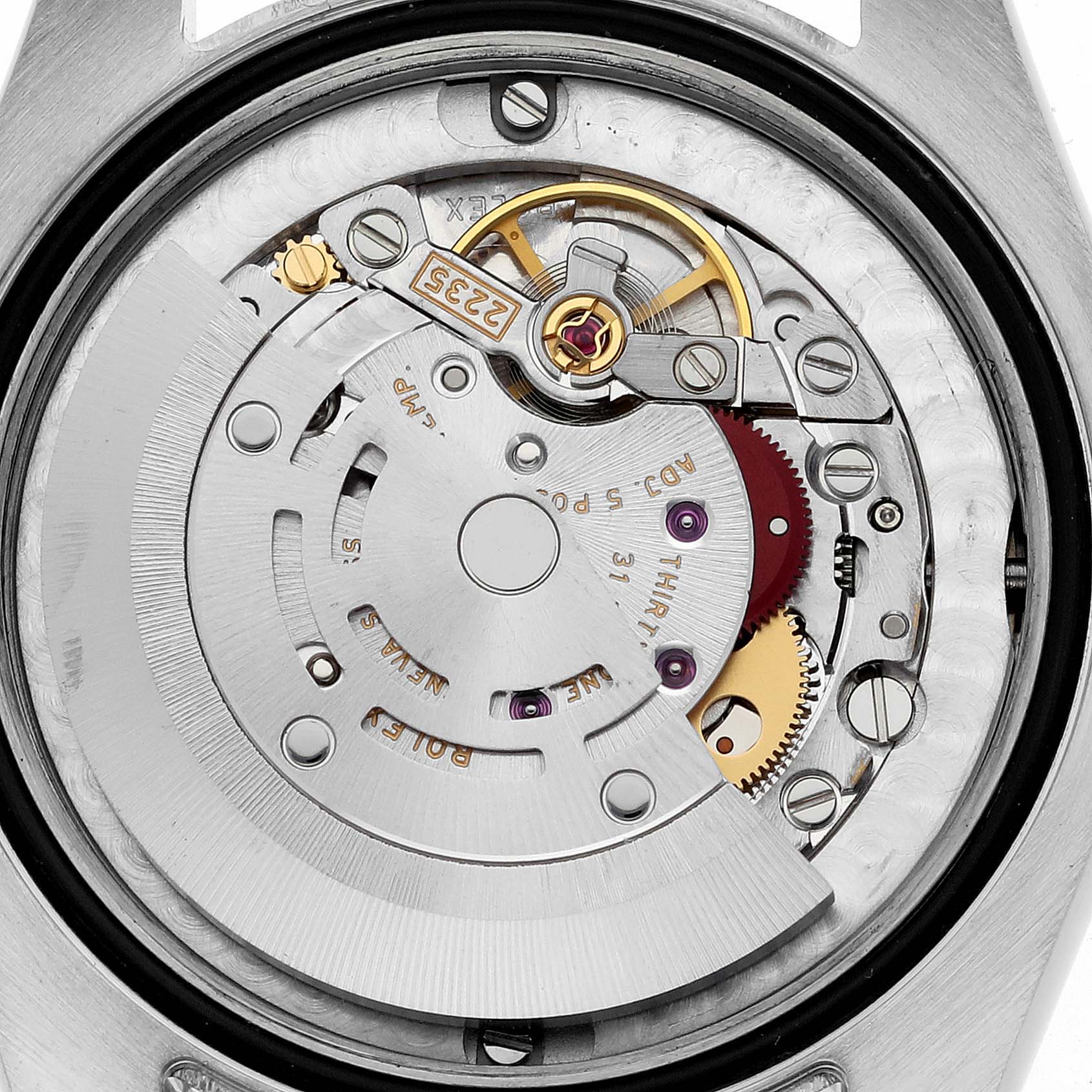 The image shows the movement and internal mechanics of a Rolex Datejust watch from a top-down angle.