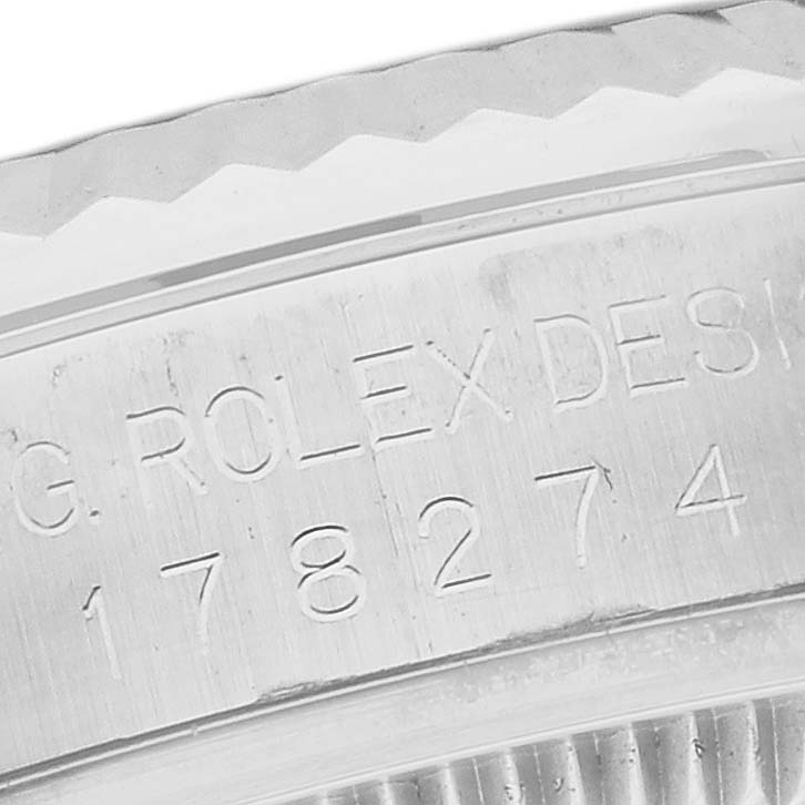 The image shows a close-up of the engraved side of a Rolex Datejust bezel.