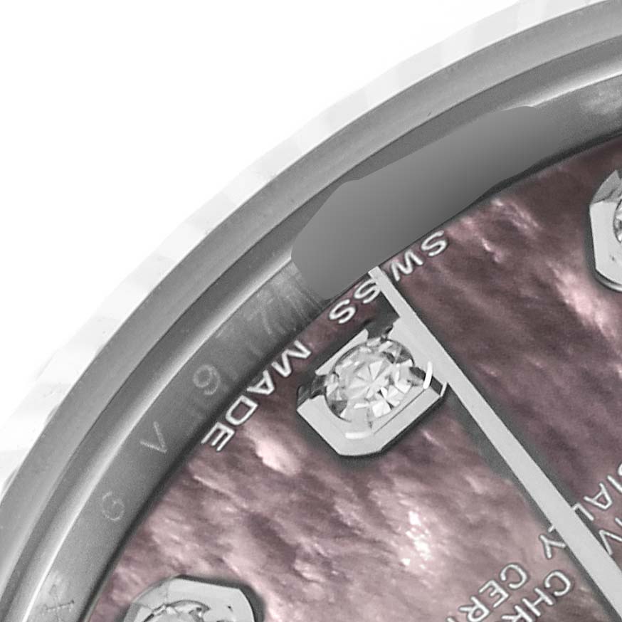 The image shows a close-up of the dial on a Rolex Datejust, highlighting the diamond markers and part of the bezel.