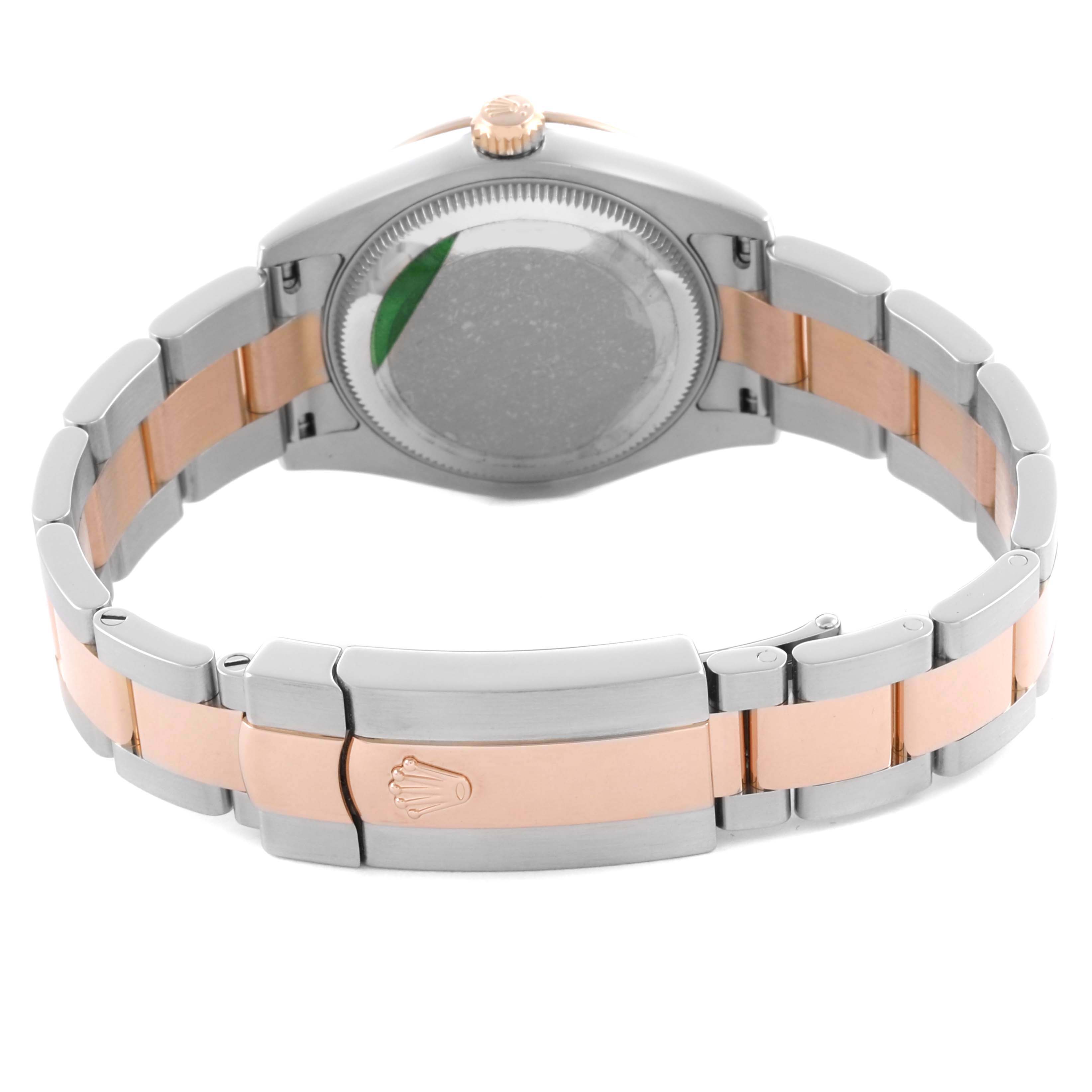 The Rolex Datejust watch is shown from the back, displaying the case back, bracelet, and clasp.