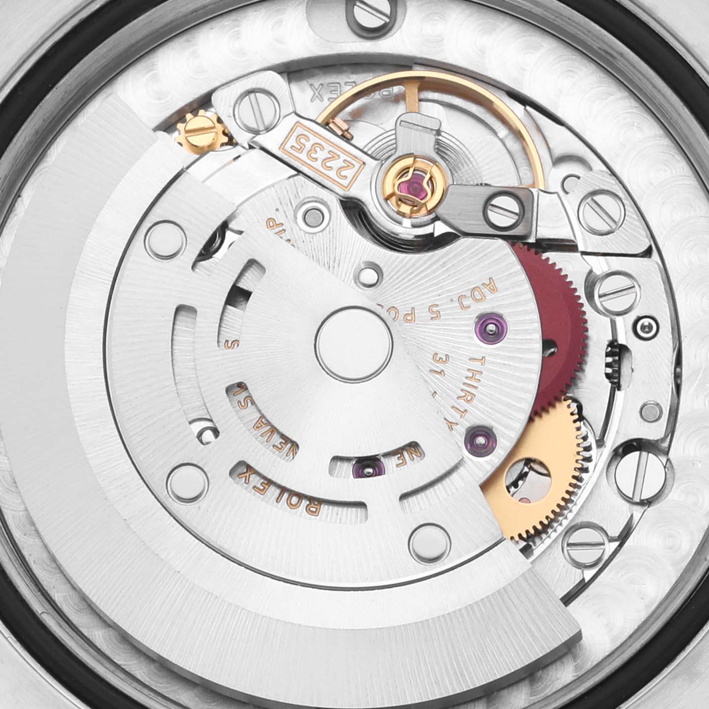 The image shows the intricate movement parts of a Rolex Datejust watch from a top-down angle.