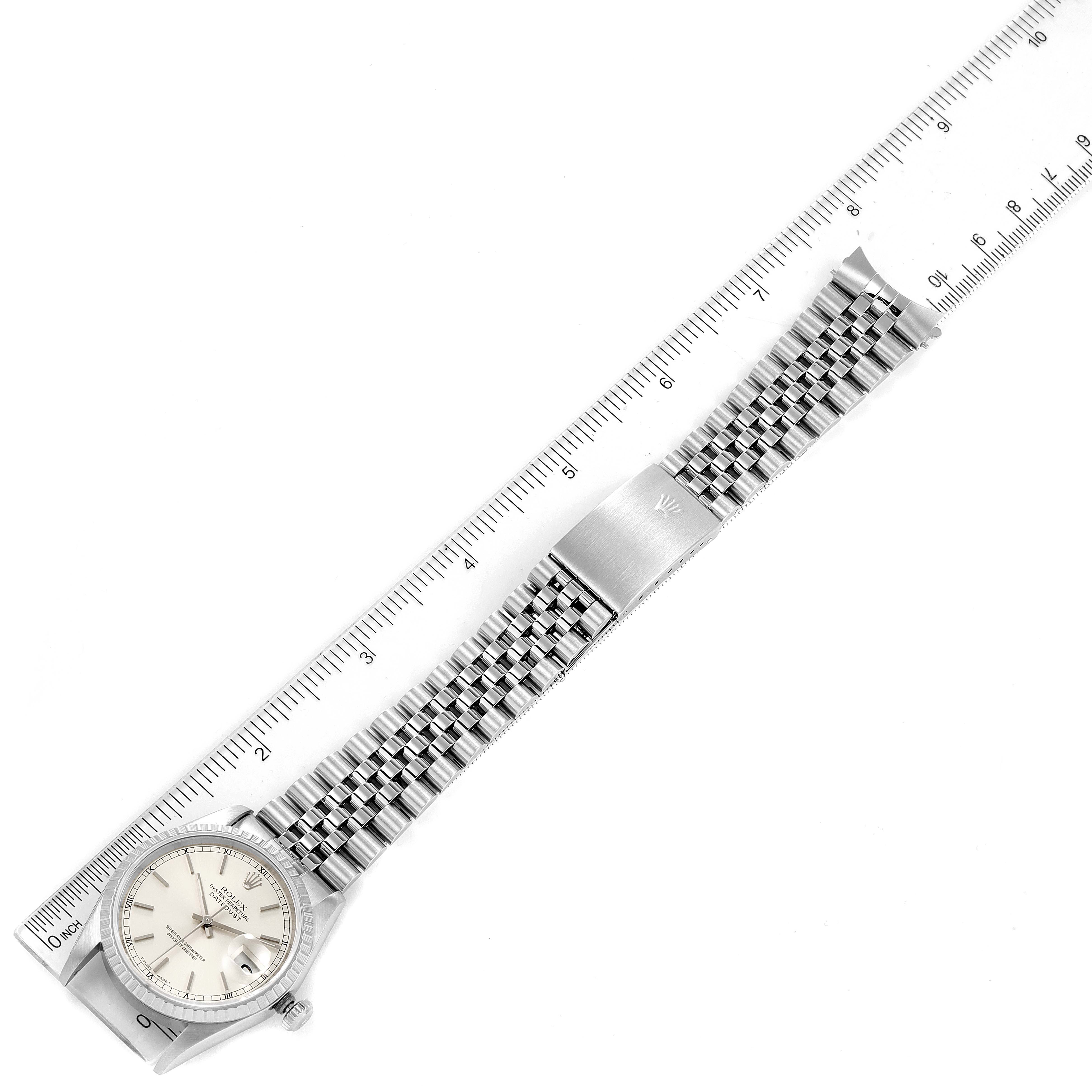 The image shows a top-down view of a Rolex Datejust 16220 Men's Stainless Steel Silver Dial 16220 Men's Stainless Steel Silver Dial watch, including the face, bezel, crown, and bracelet, measured against a ruler.