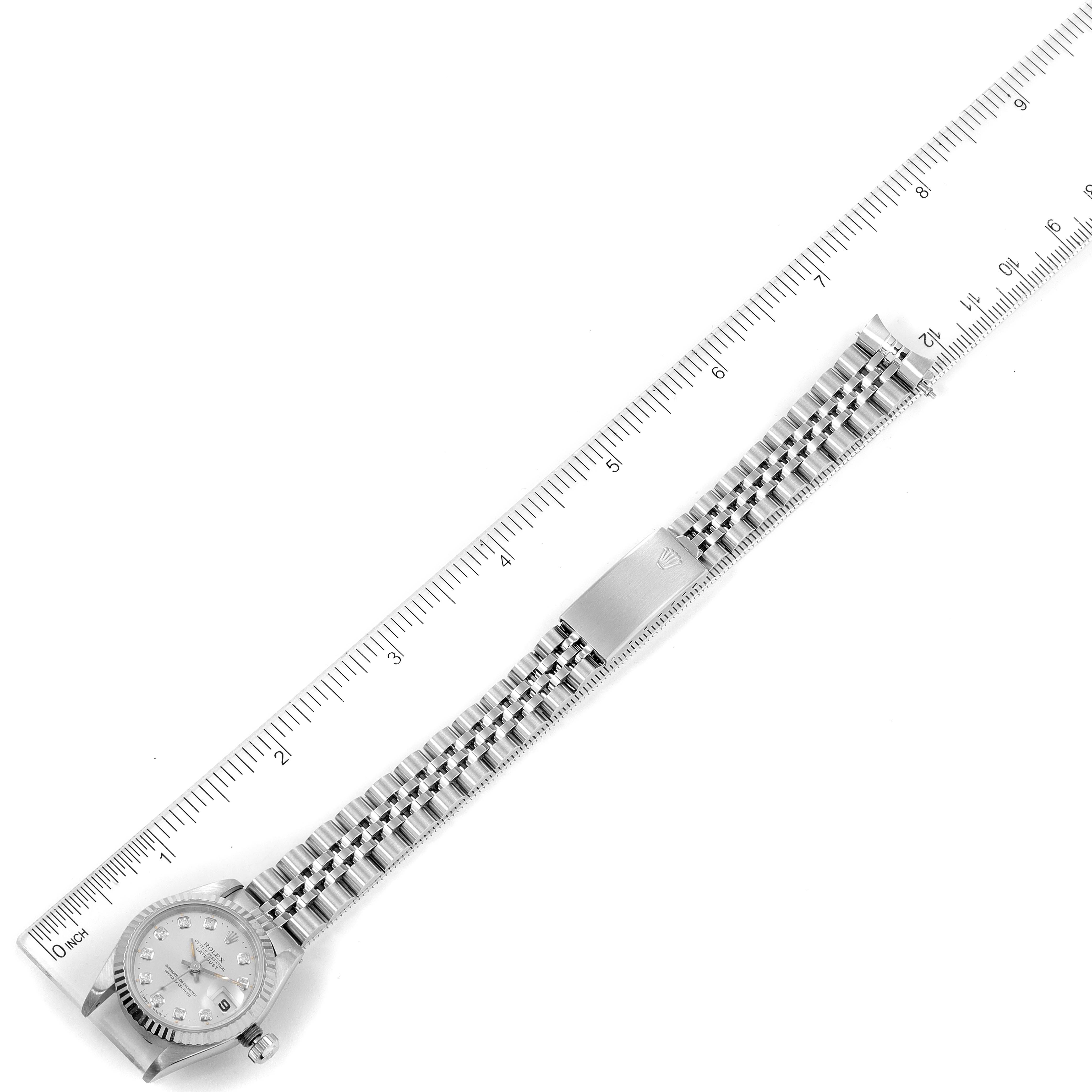 This image shows the Rolex Datejust 69174 Women's Stainless Steel Silver Dial 69174 Women's Stainless Steel Silver Dial watch fully extended next to a ruler.