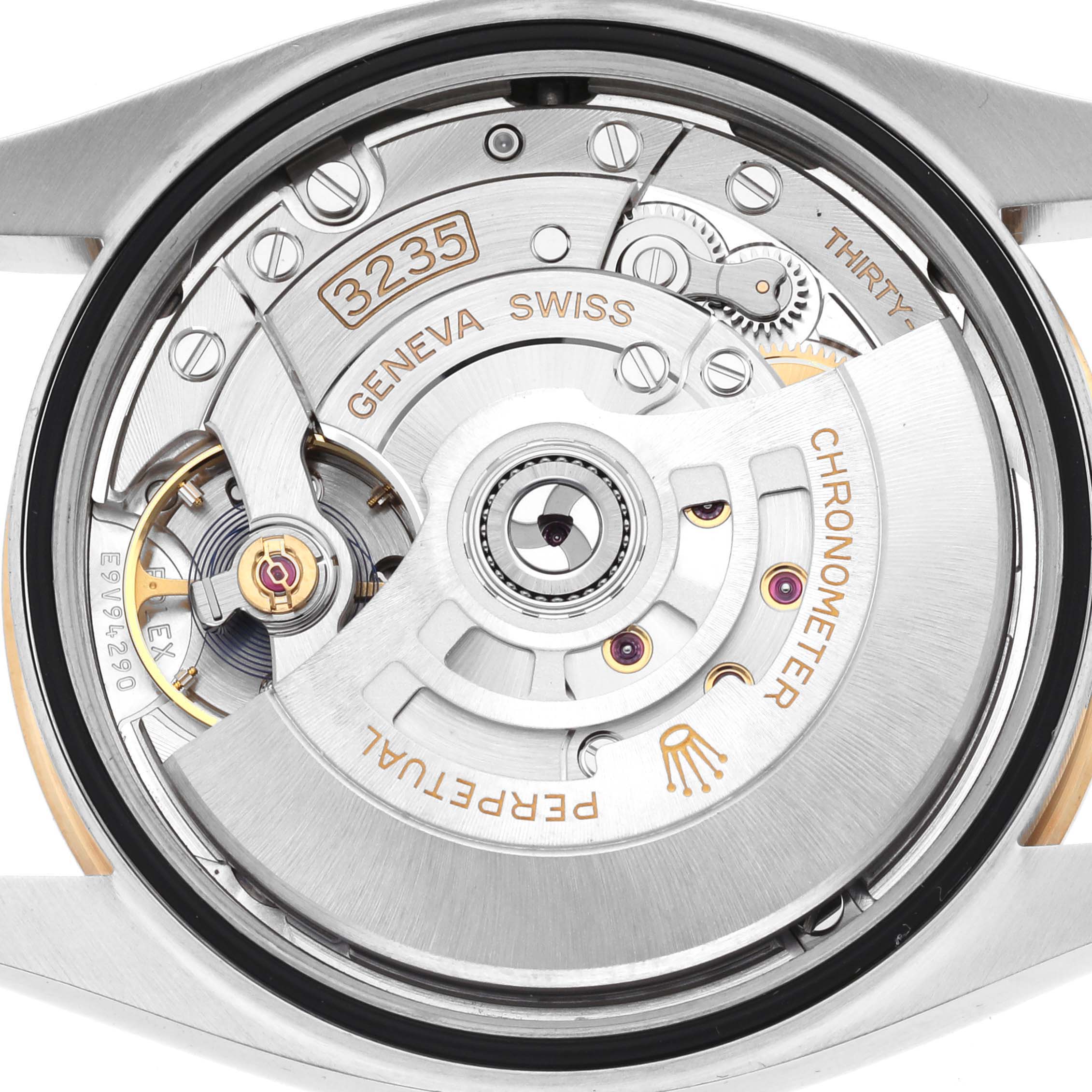 The image shows the movement of a Rolex Datejust 126233 Men's Steel and Gold (two tone) Black Dial watch, displaying its intricate mechanical parts from the back.