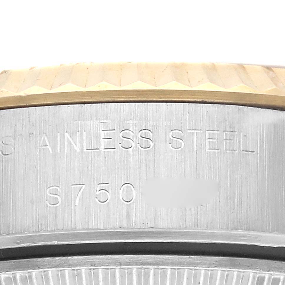 The image shows a close-up of the side of a Rolex Datejust 69173 Women's Steel and Gold (two tone) Champagne Dial 69173 Women's Steel and Gold (two tone) Champagne Dial watch, highlighting the stainless steel engraving and fluted bezel.