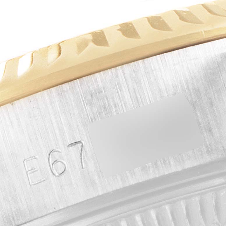 This close-up image shows the engraved serial number on the side of the bezel of a Rolex Datejust 69173 Women's Steel and Gold (two tone) Black Dial 69173 Women's Steel and Gold (two tone) Black Dial watch.