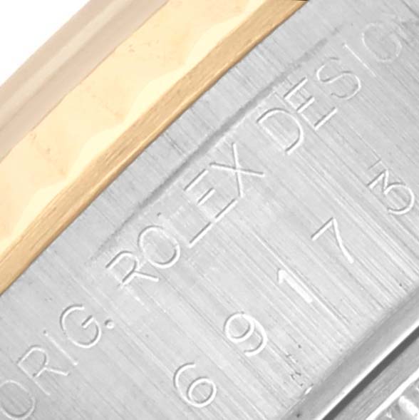 The image shows a close-up of the case engraving and edge of the bezel of the Rolex Datejust 69173 Women's Steel and Gold (two tone) Blue Dial 69173 Women's Steel and Gold (two tone) Blue Dial.