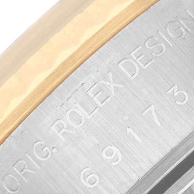 The image shows a close-up of the side engraving on a Rolex Datejust 69173 Women's Steel and Gold (two tone) Blue Dial 69173 Women's Steel and Gold (two tone) Blue Dial watch, highlighting the brand's design marking.