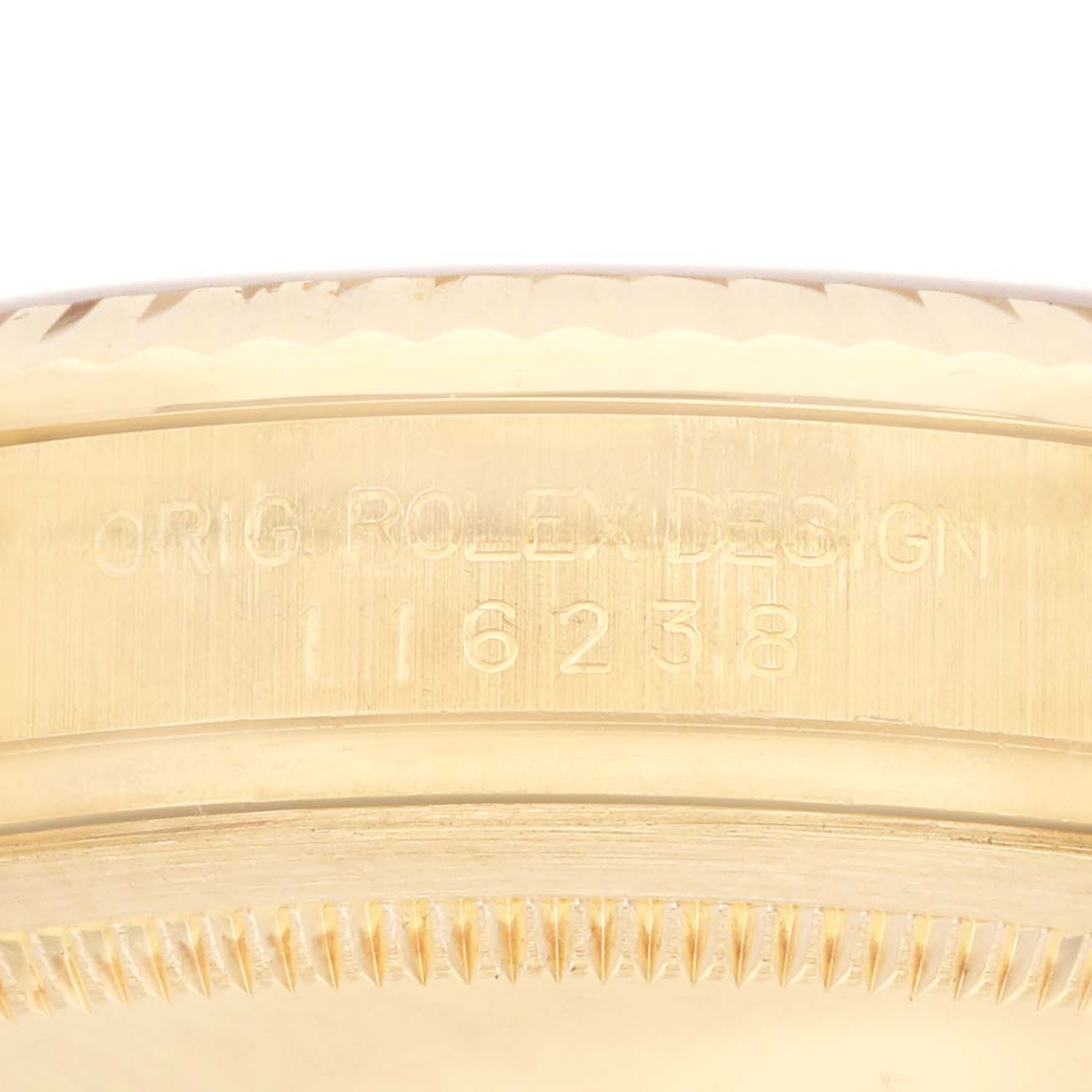 The image shows a close-up of the side of a Rolex Datejust 116238 Men's Yellow Gold Silver Dial 116238 Men's Yellow Gold Silver Dial, featuring the model number and fluted bezel.