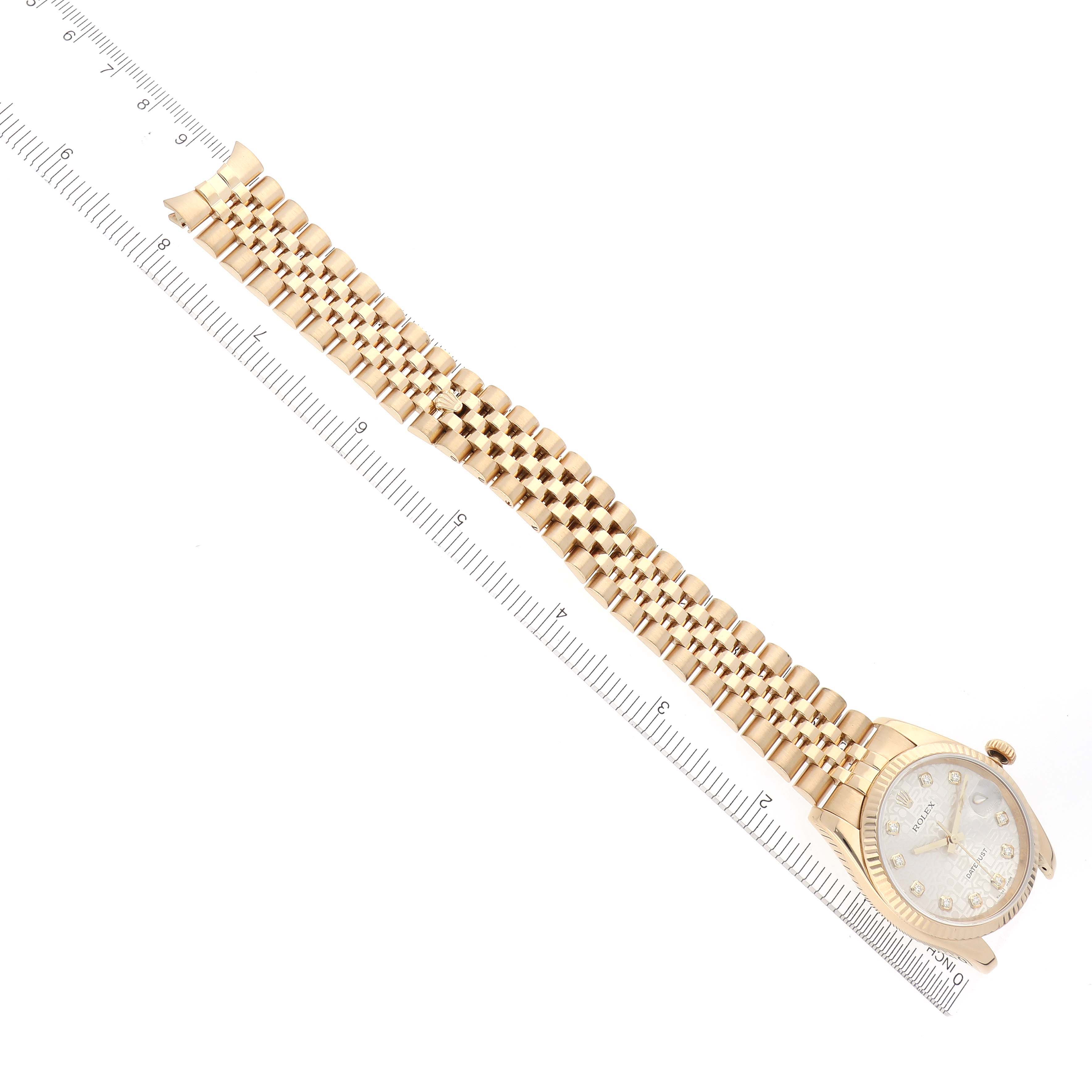 The Rolex Datejust 116238 Men's Yellow Gold Silver Dial 116238 Men's Yellow Gold Silver Dial watch is shown lying flat, displaying the face and entire bracelet alongside a ruler for scale.