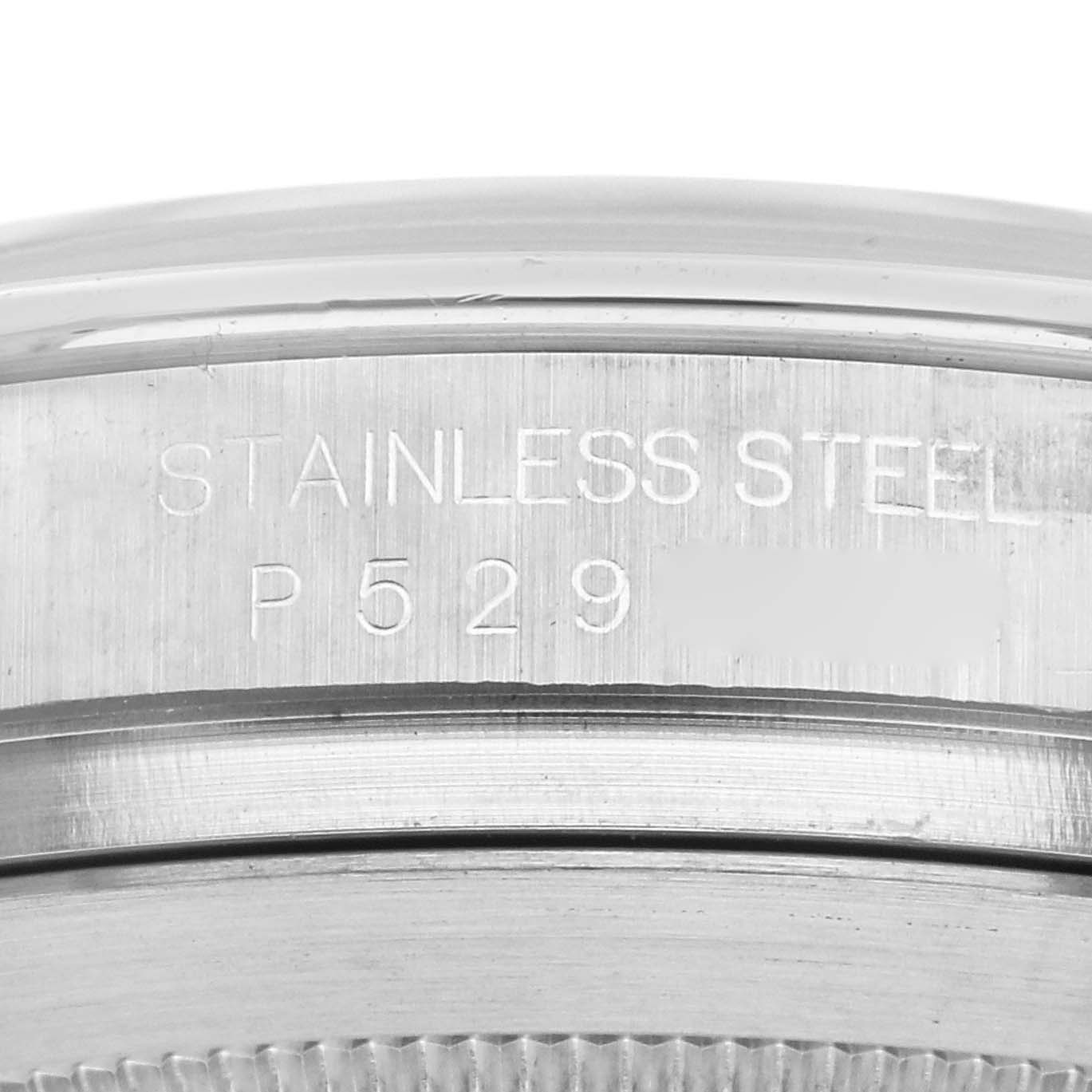 The image shows a close-up of the Rolex Daytona 116520 Men's Stainless Steel White Dial 116520 Men's Stainless Steel White Dial's case, highlighting the "STAINLESS STEEL" engraving.