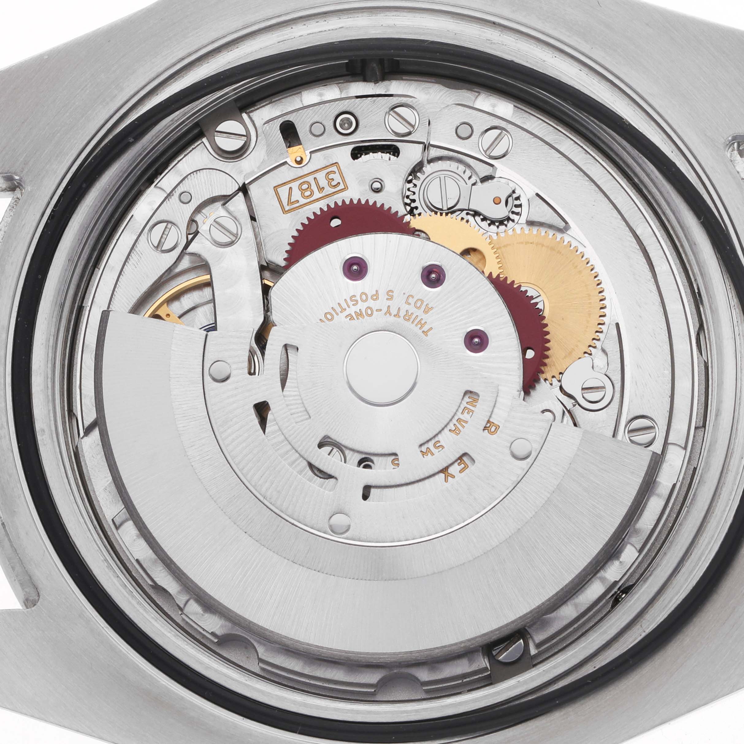 The image shows the movement of a Rolex Explorer 216570 Men's Stainless Steel White Dial watch, viewed from the back, highlighting the gears and mechanical components.