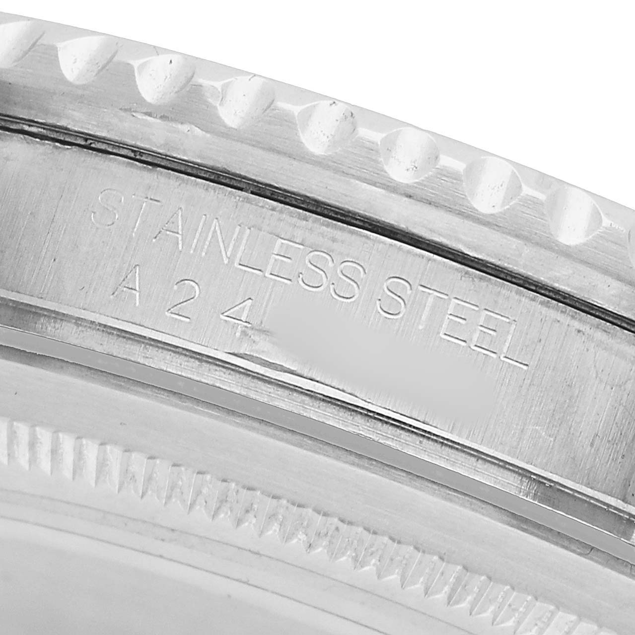 The image shows a close-up of the back casing edge of a Rolex GMT-Master 16700 Men's Stainless Steel Black Dial, highlighting the stainless steel marking.