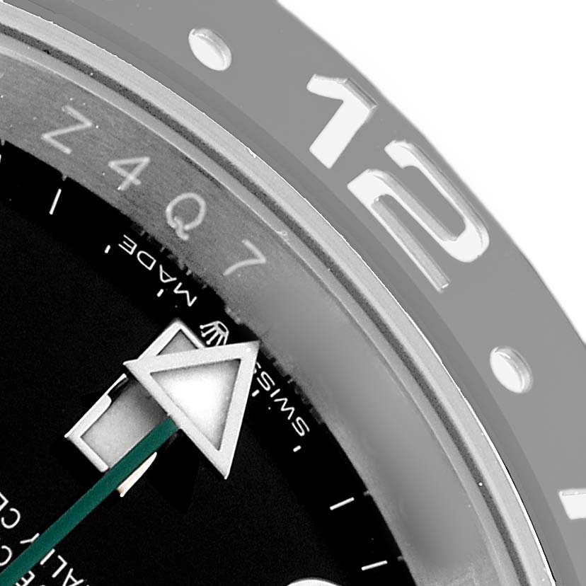 The image shows a close-up of the Rolex GMT-Master 126710 Men's Stainless Steel Black Dial's bezel with the 12 o'clock marker and the triangular GMT hand.