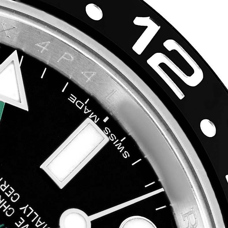 The image shows a close-up angle of the bezel and part of the dial of a Rolex GMT-Master 116710 Men's Stainless Steel Black Dial.
