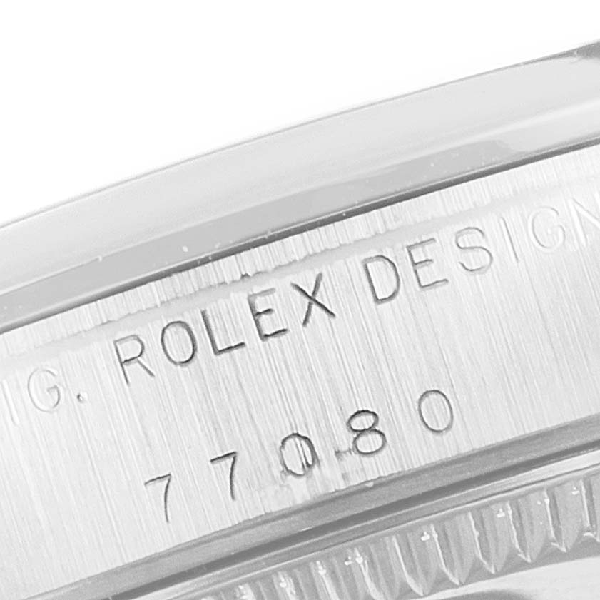 This image shows a close-up of the serial number engraving on the casing of a Mid-Size Rolex model watch.