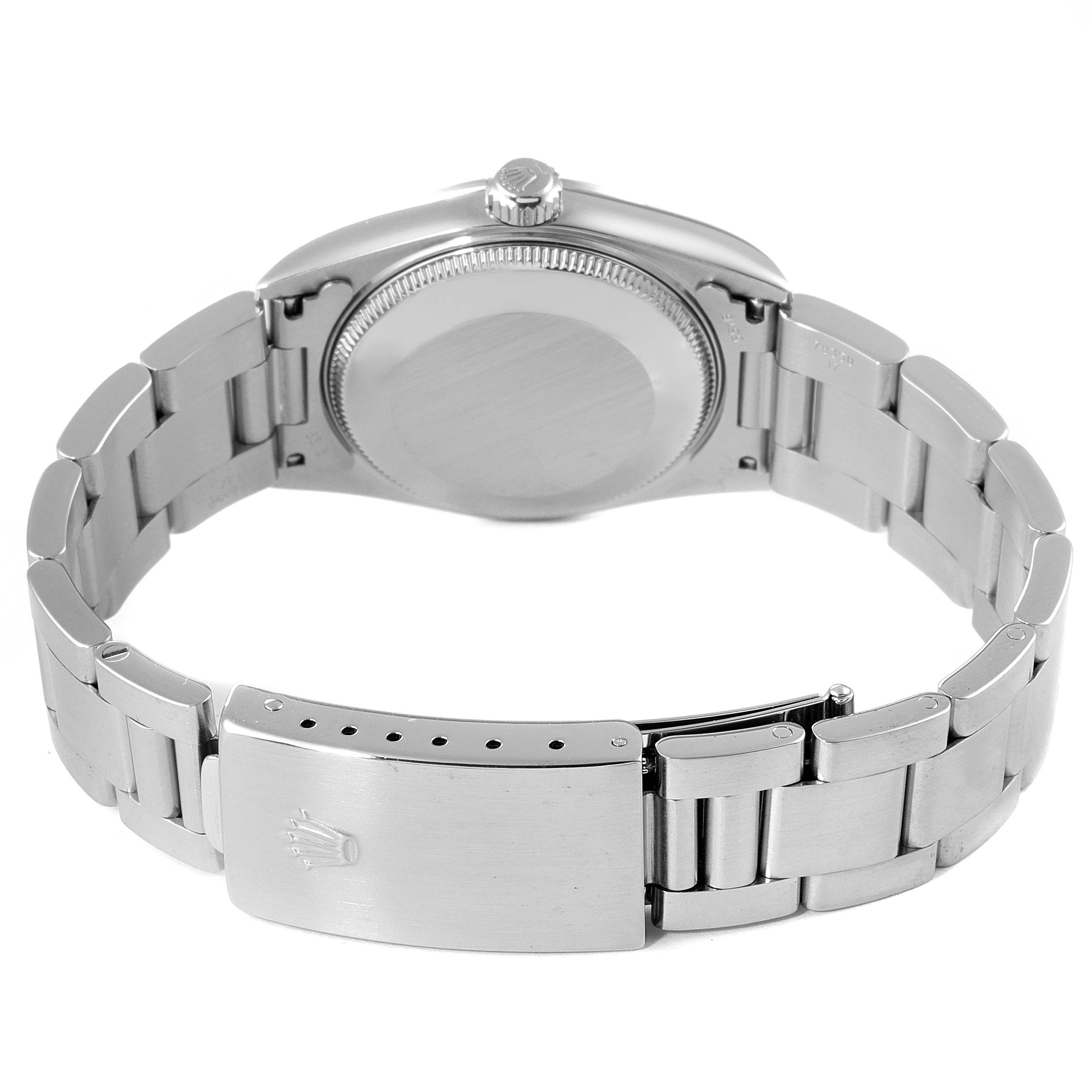 The image shows the back view of the Mid-Size Rolex watch, focusing on the case back, bracelet, and clasp.