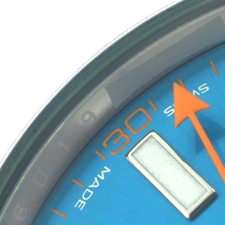 The image shows a close-up of the Rolex Milgauss 116400GV Men's Stainless Steel Blue Dial 116400GV Men's Stainless Steel Blue Dial watch face featuring the hour marker and part of the orange second hand.