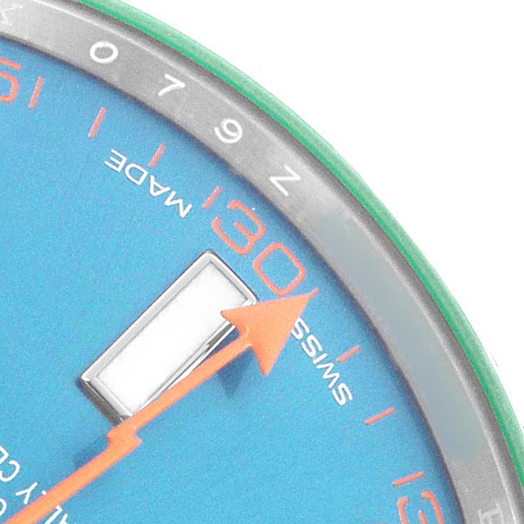 The image shows a close-up of the Rolex Milgauss 116400GV Men's Stainless Steel Blue Dial watch face, highlighting the orange second hand, blue dial, and part of the chapter ring.