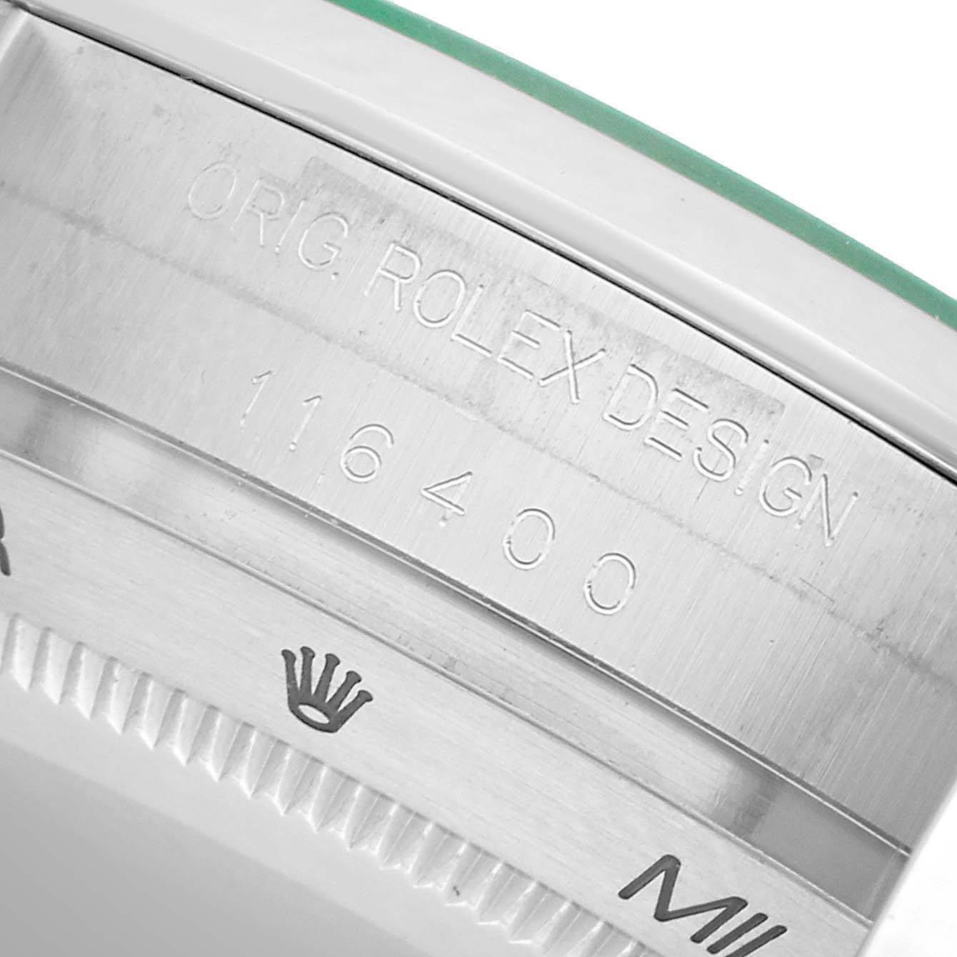The image shows a close-up of the Rolex Milgauss 116400GV Men's Stainless Steel Blue Dial case, focusing on its engraved design details and model number.